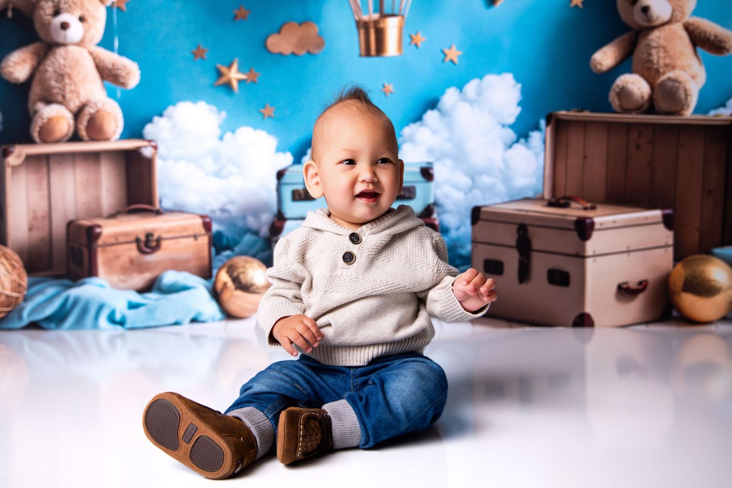 A collection of baby photography images featuring vintage suitcases, teddy bears, and dreamy blue backgrounds.