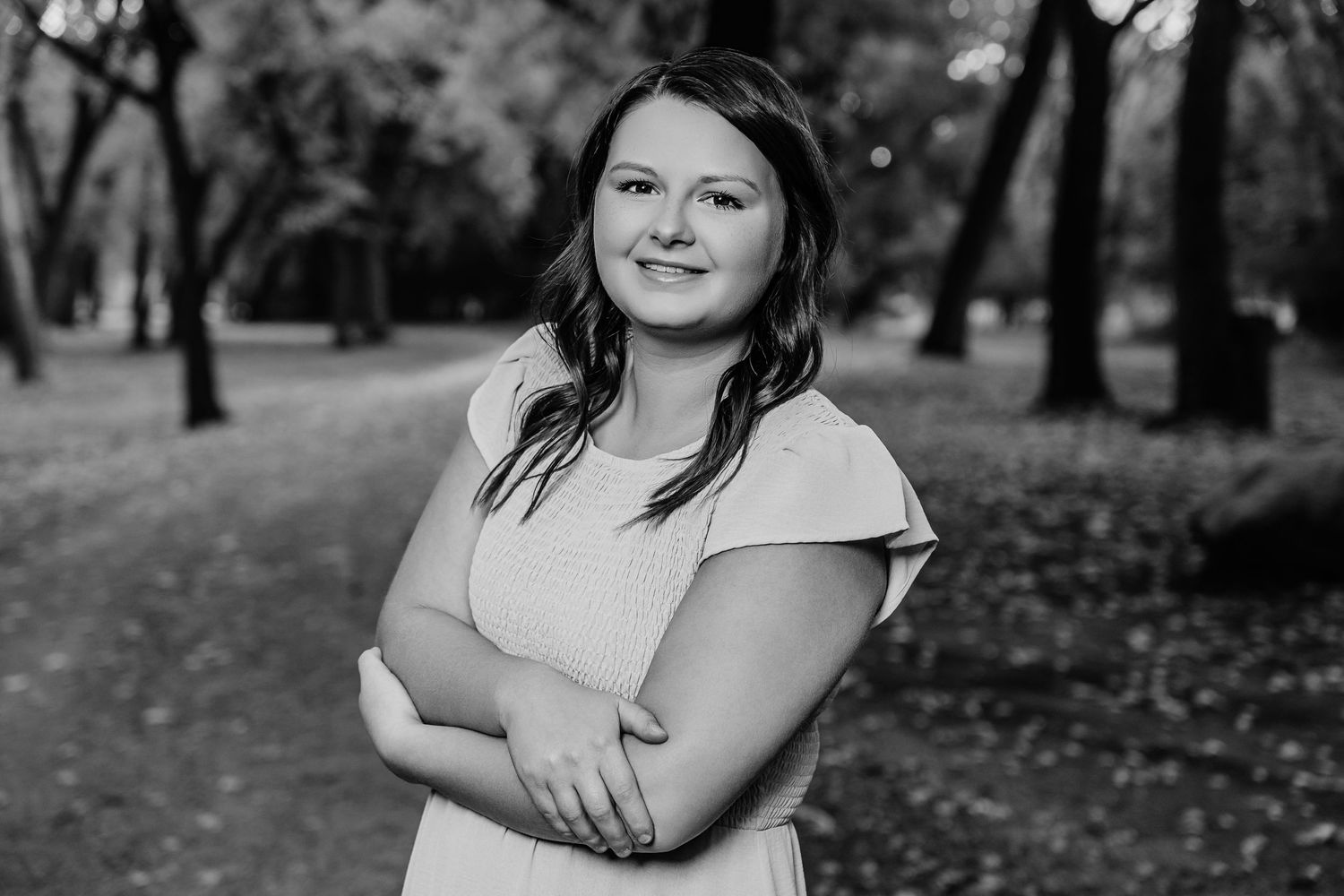 Family portrait session in a wooded park during autumn with black and white photography.