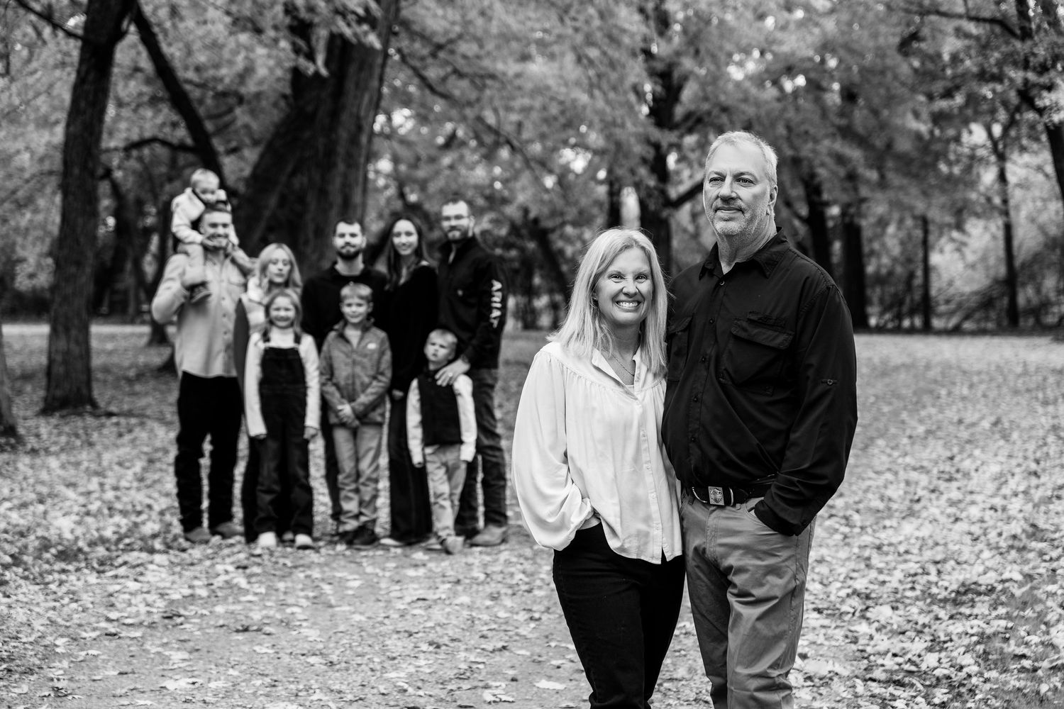 Black and white photos of people walking and interacting in an outdoor fall setting.