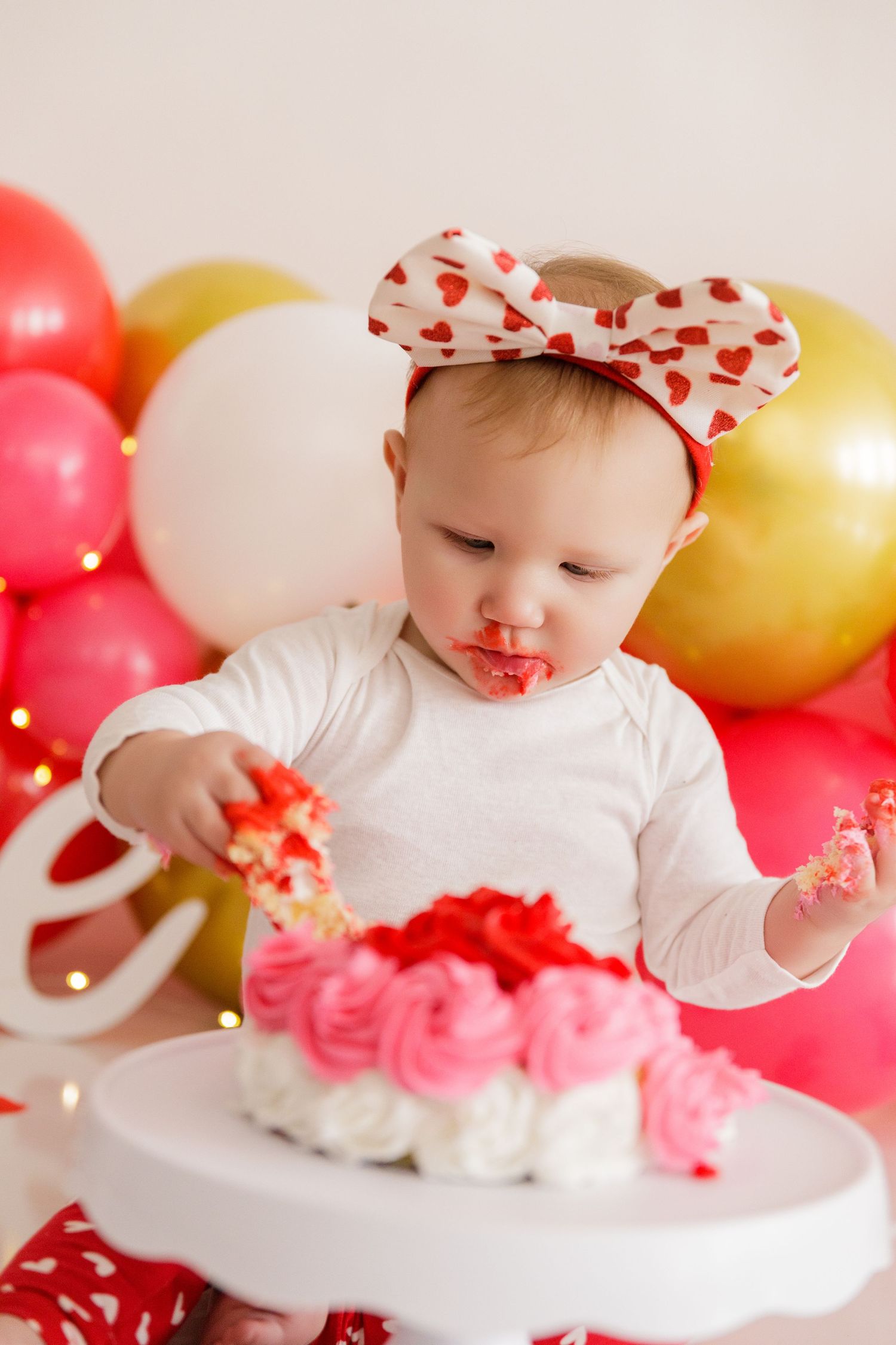 White and red themed Valentine's Day setup with balloons and decorative elements.