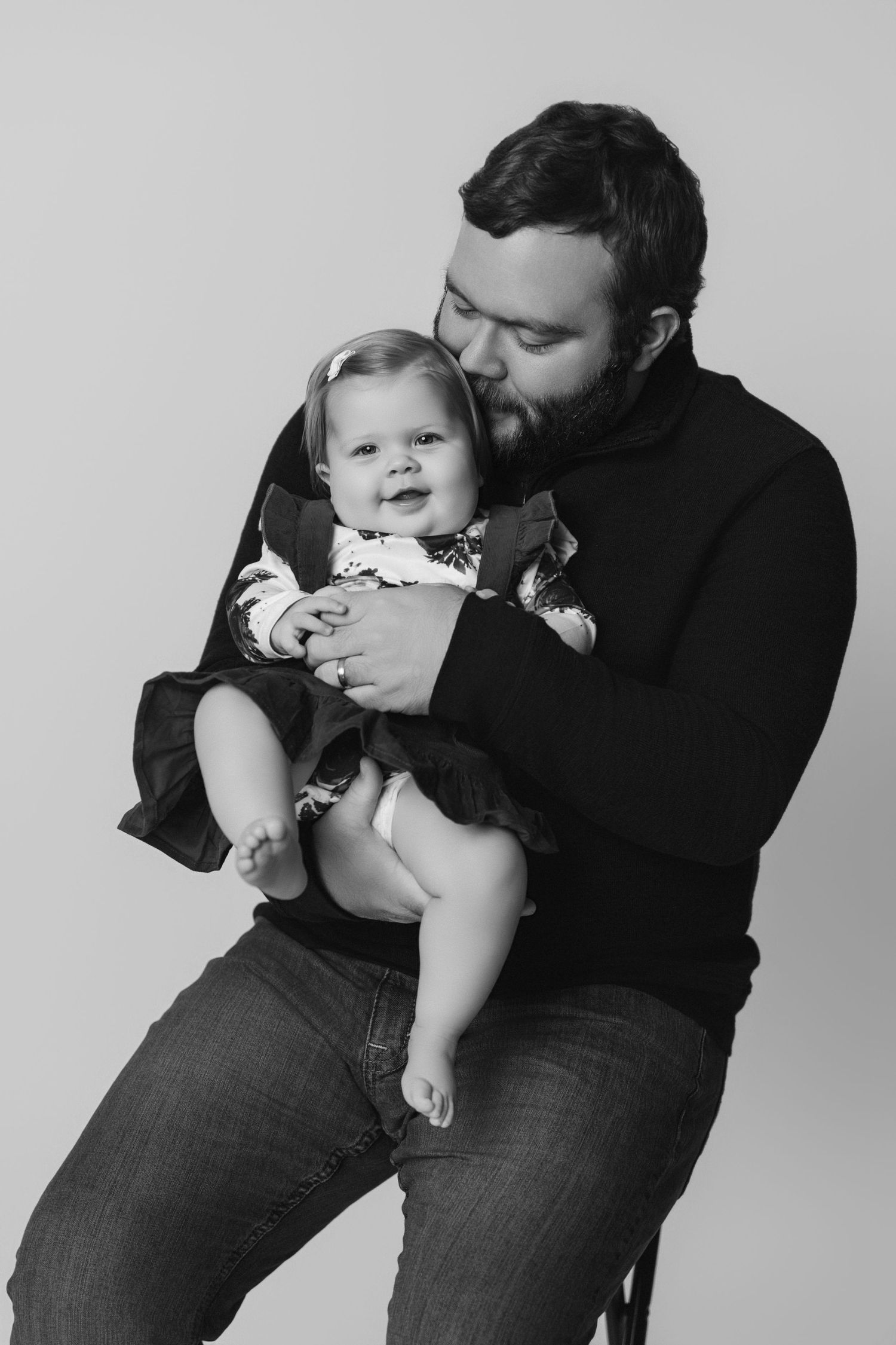 Black and white series of intimate family moments showing parent and baby in casual poses.
