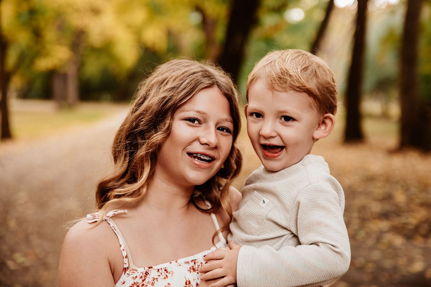 Candid moments of joy captured between family members in an autumn setting.