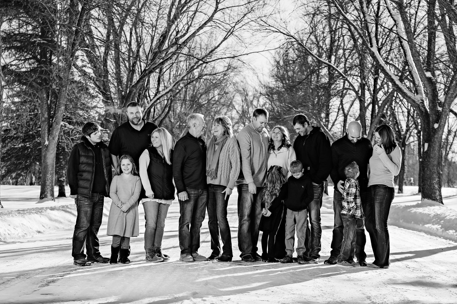 Black and white photo of extended family standing together in a winter park setting.