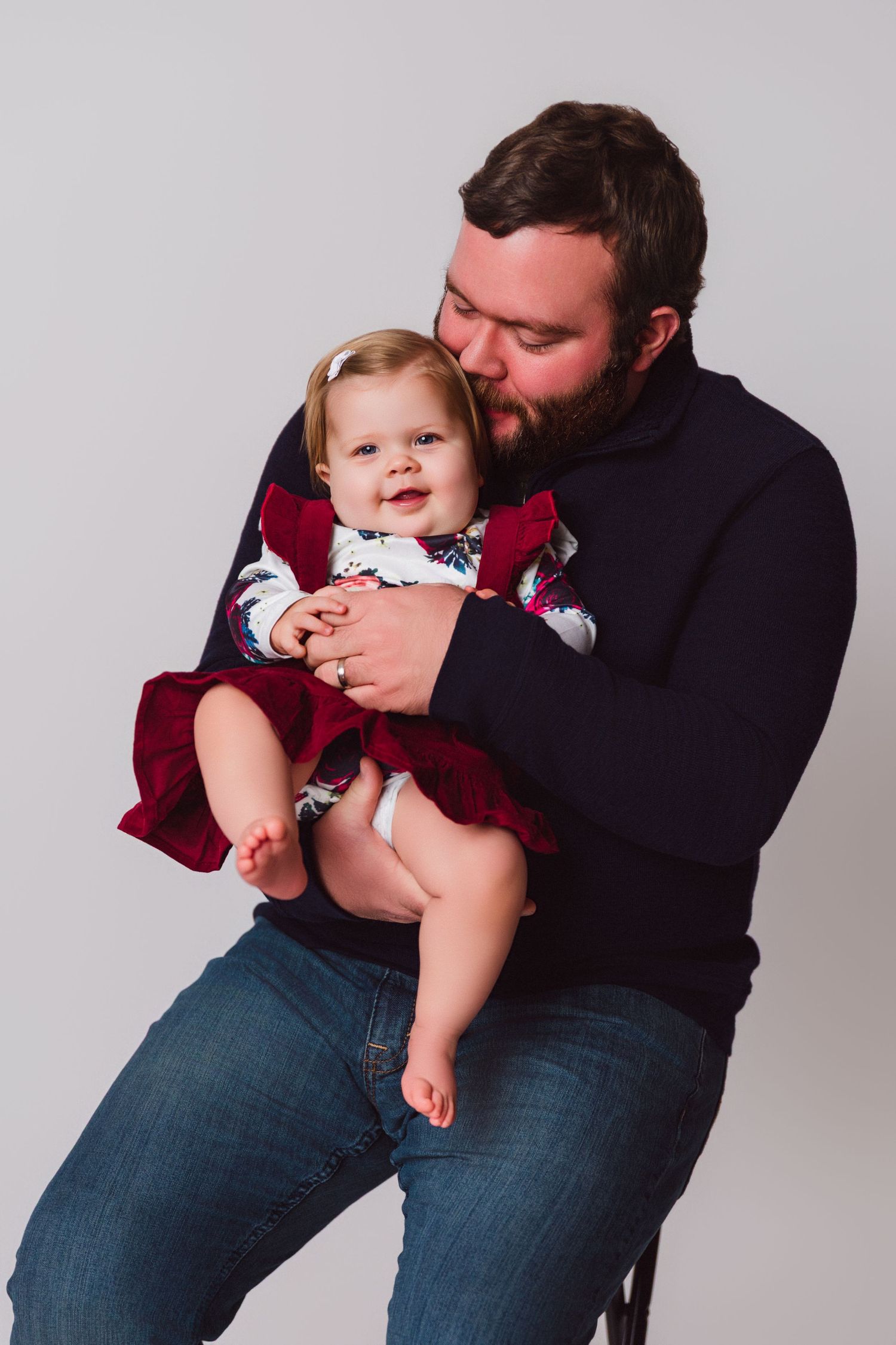 Parent and baby sharing tender moments in a series of black and white portraits.