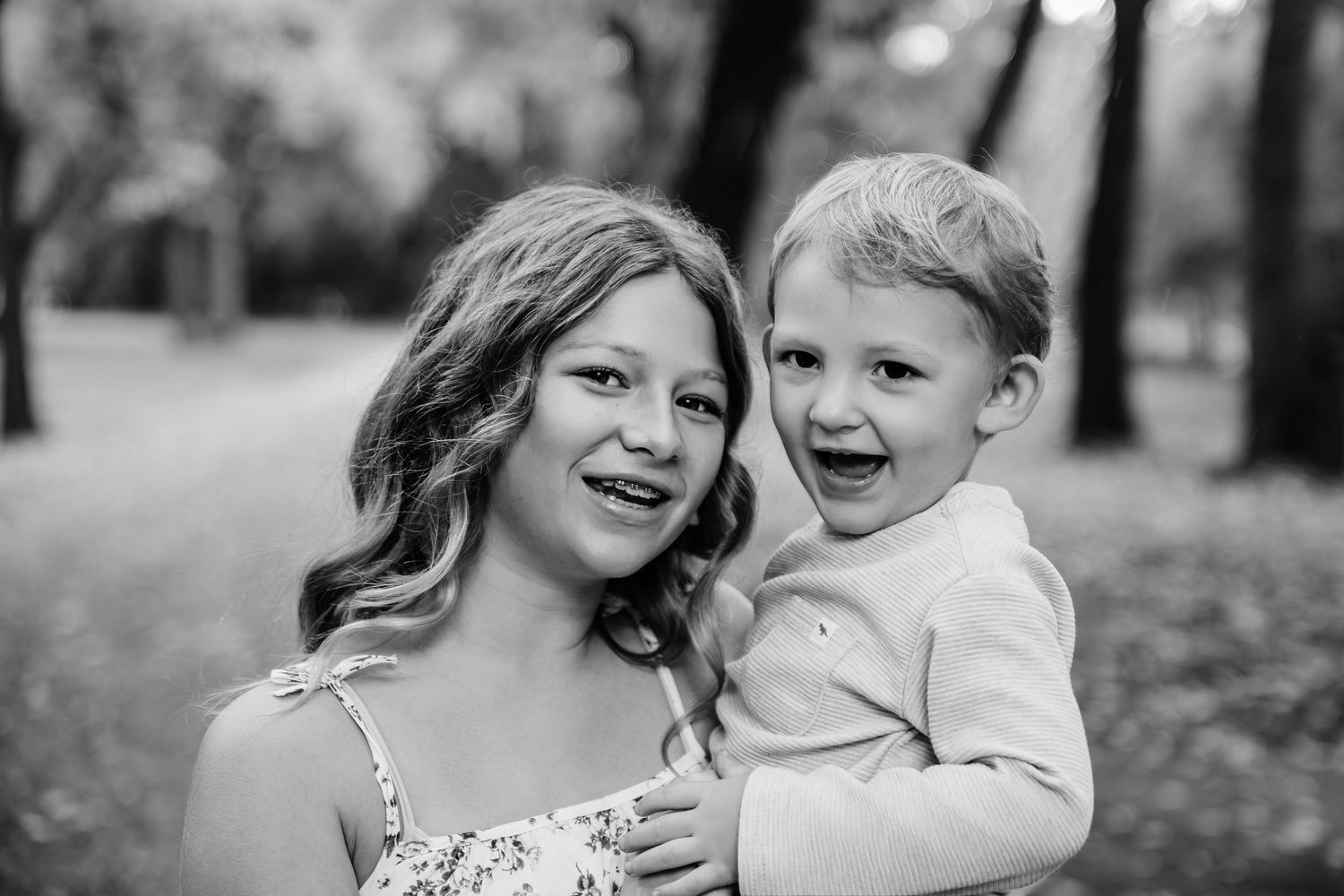 Series of intimate black and white family portraits in a natural outdoor setting.