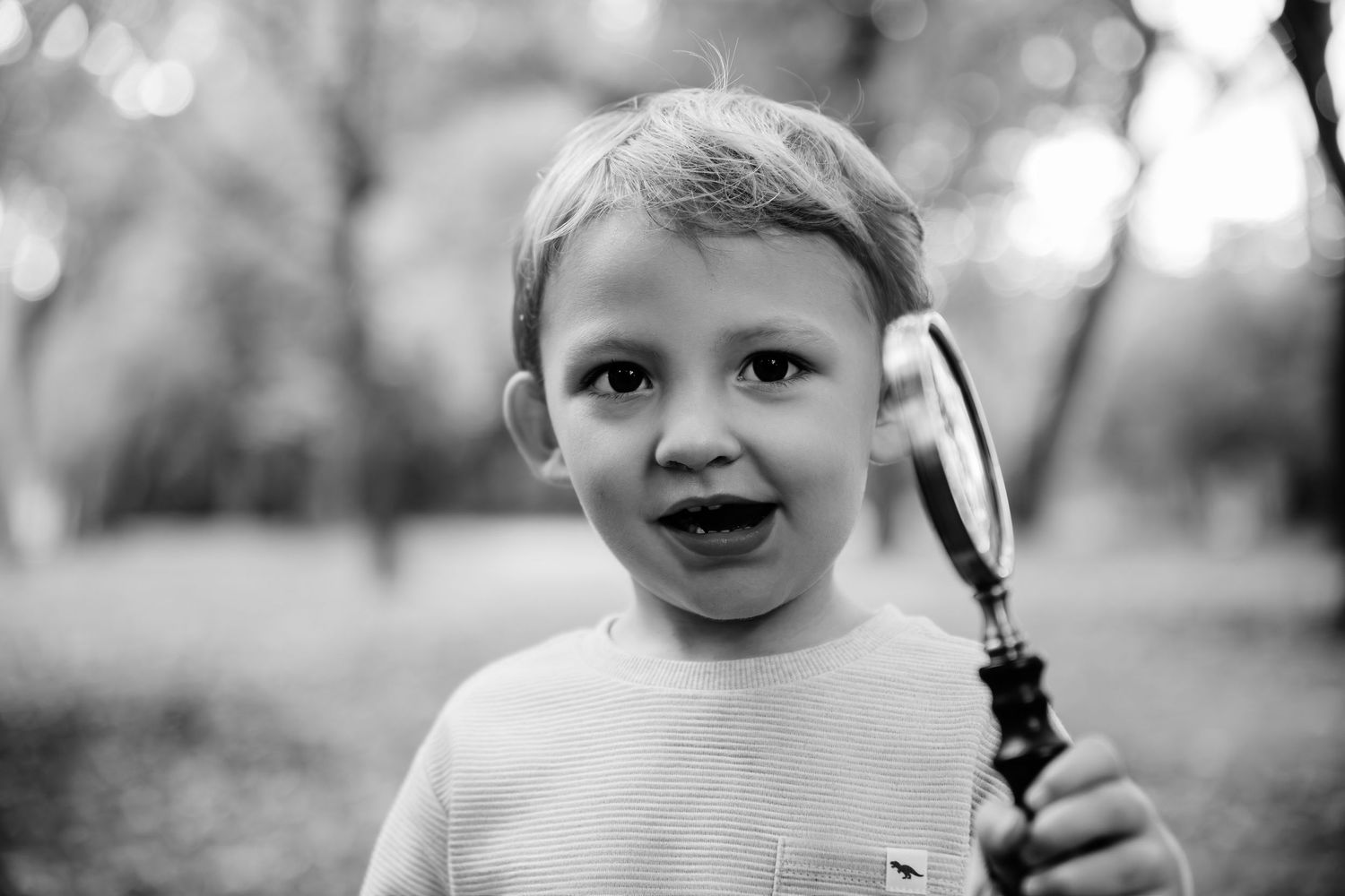 Black and white candid portraits capturing playful expressions in natural light.