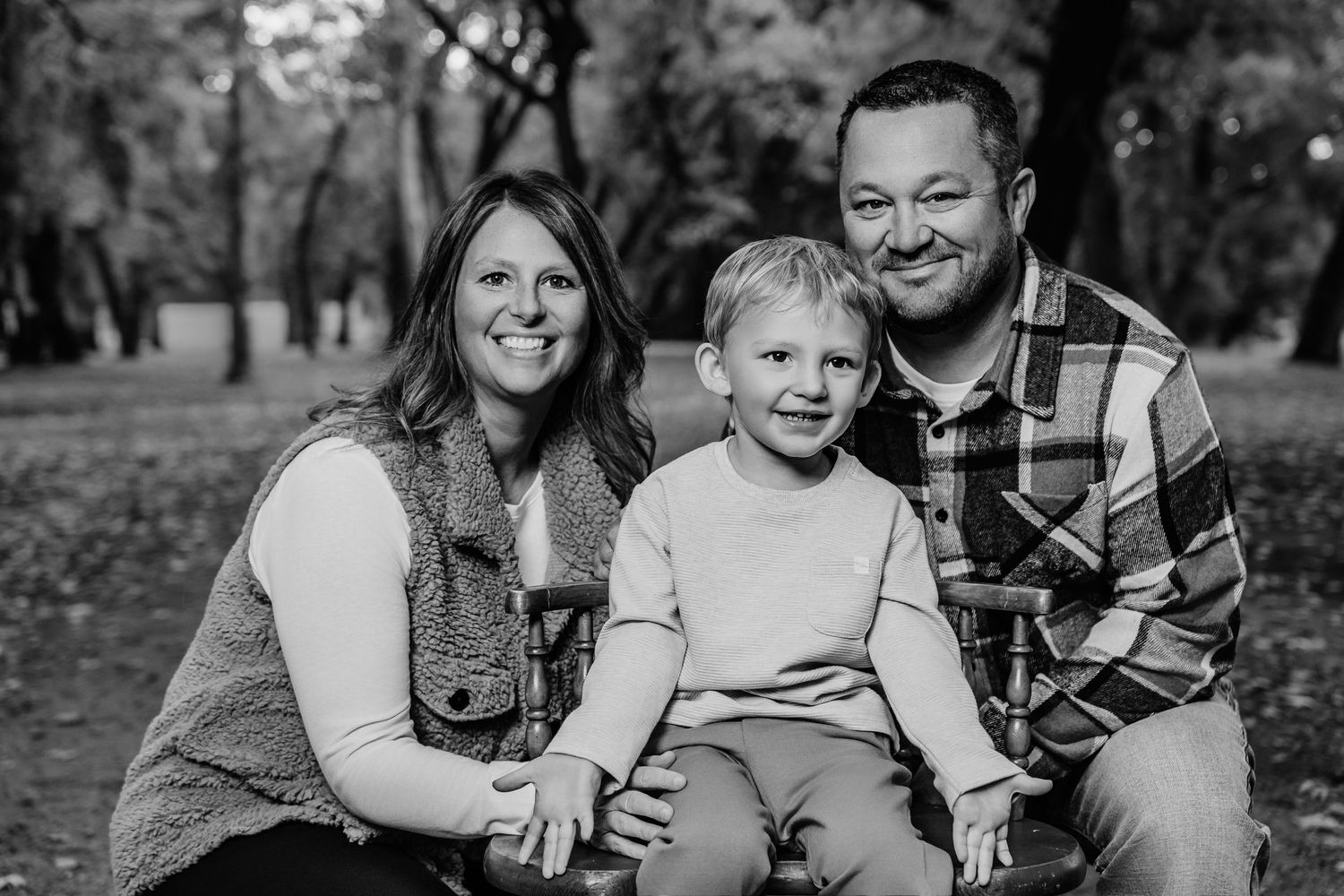 Candid family moment captured in black and white photography outdoors.