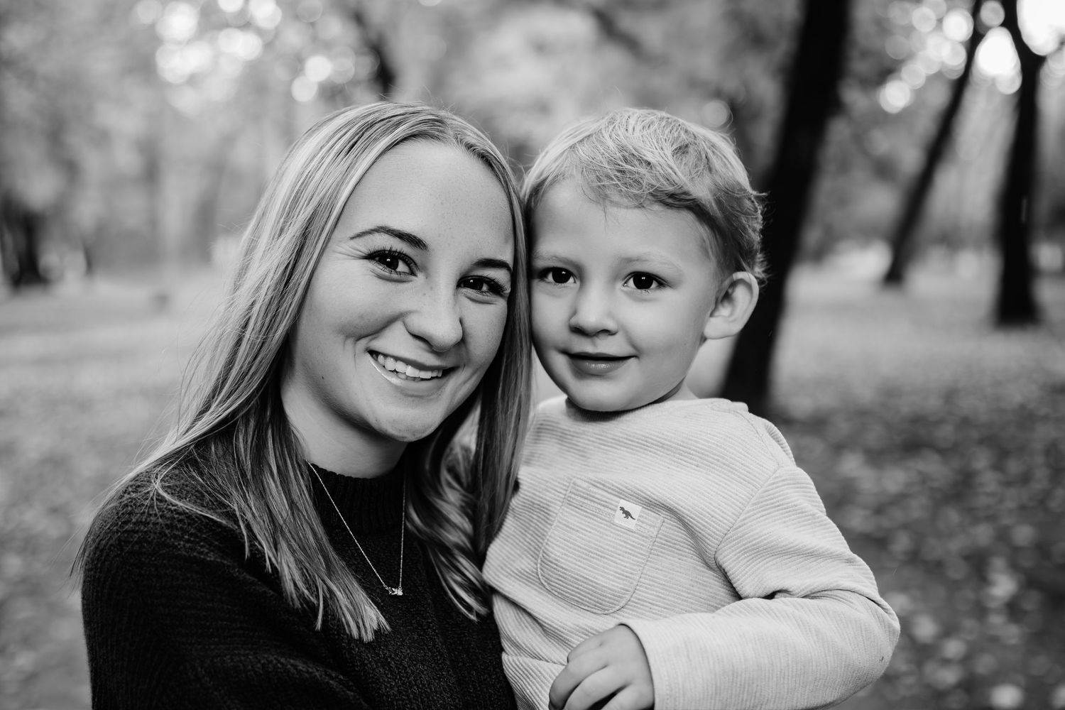 A family shares intimate moments together during an outdoor photo session.