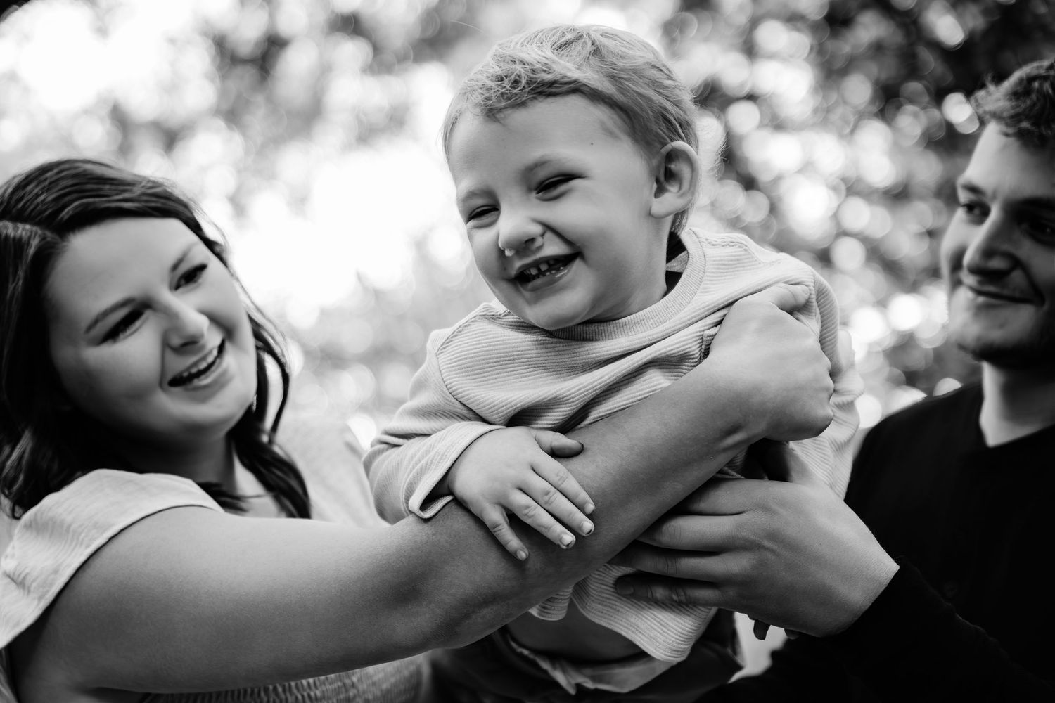 Black and white candid shots showing joyful interactions and genuine laughter.