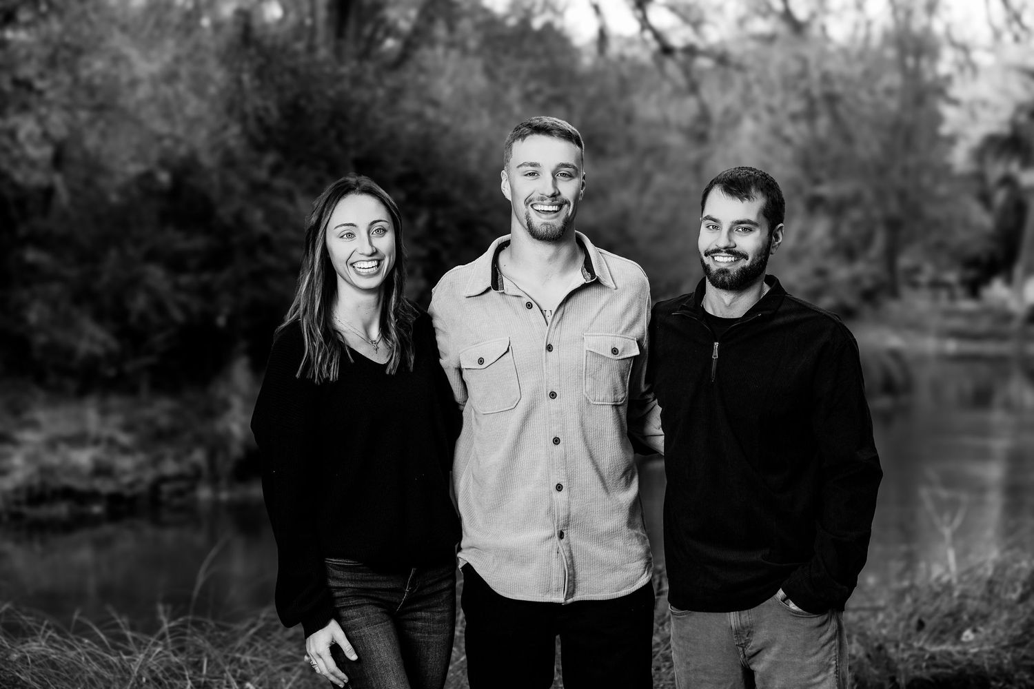Group of friends enjoying a relaxed moment together during an outdoor fall photo session.