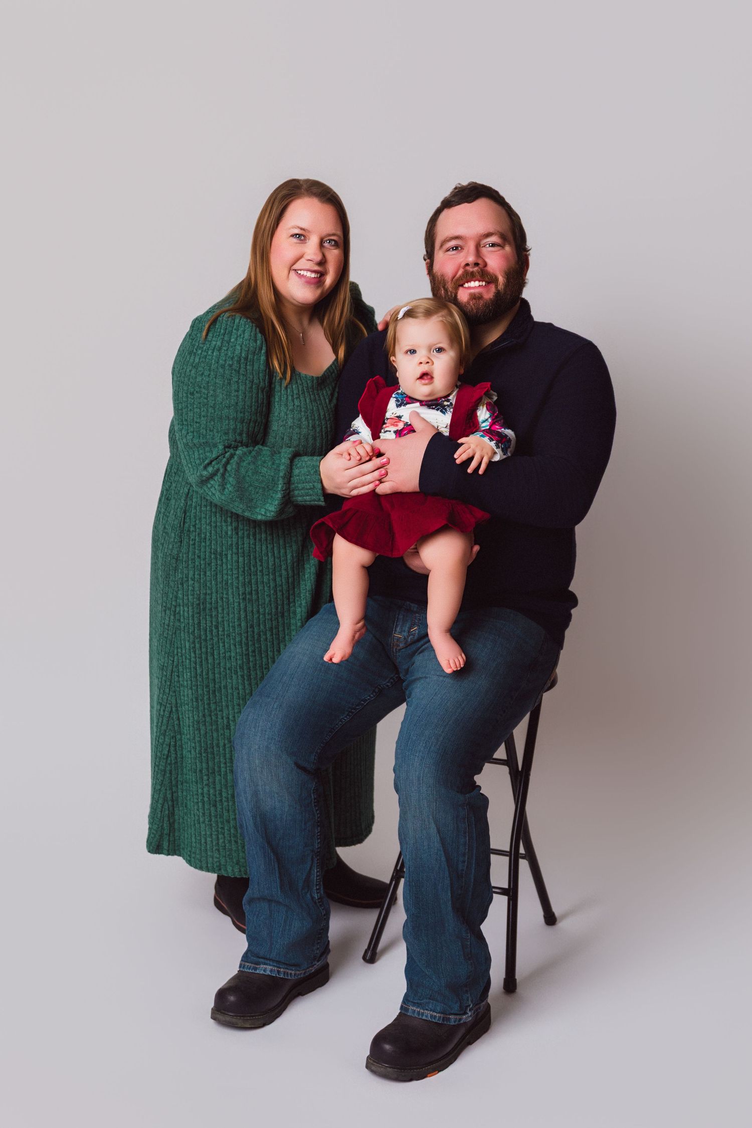 Family portrait series showing playful interactions against a light gray backdrop.