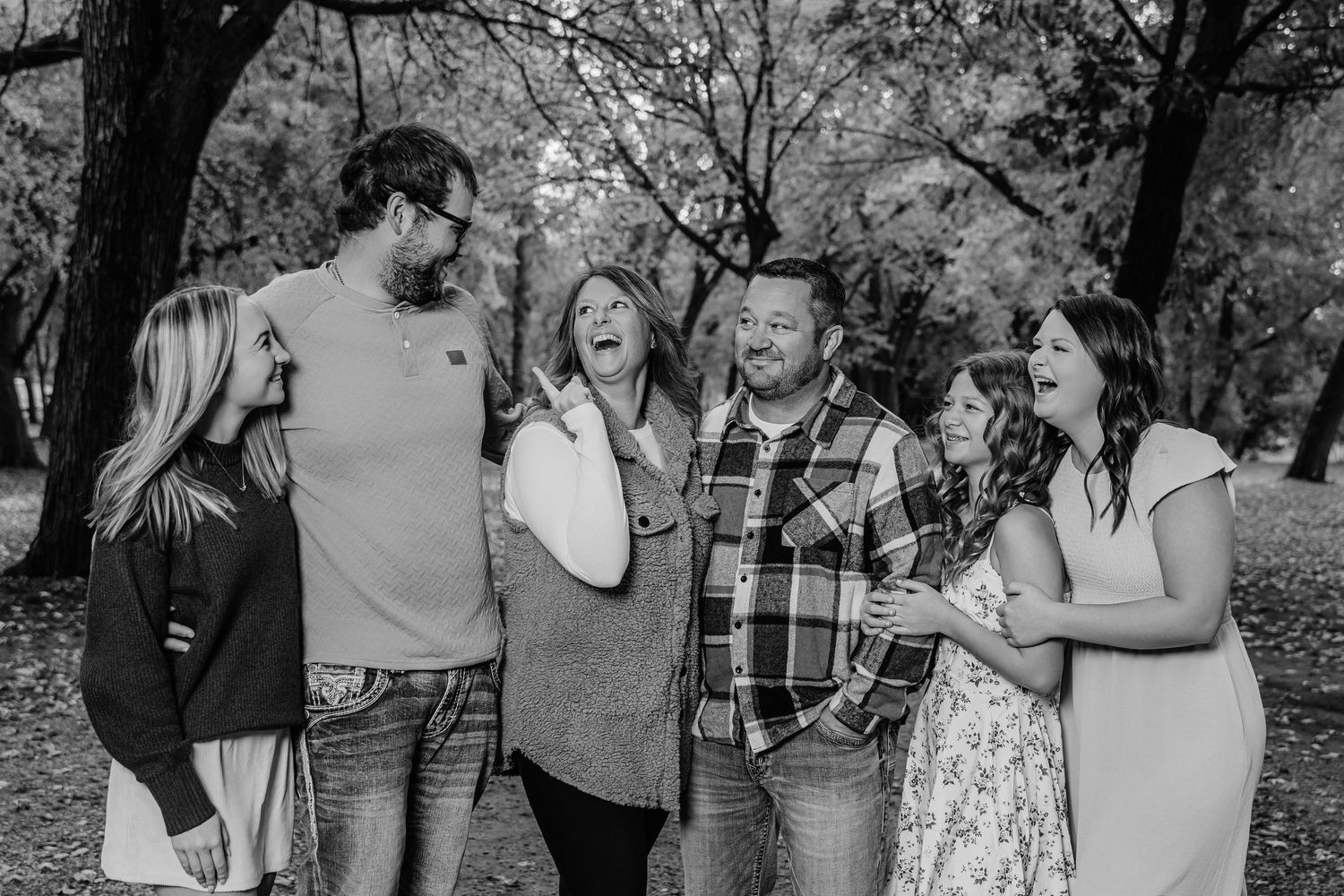 Group of friends laughing and enjoying themselves outdoors in a casual setting.