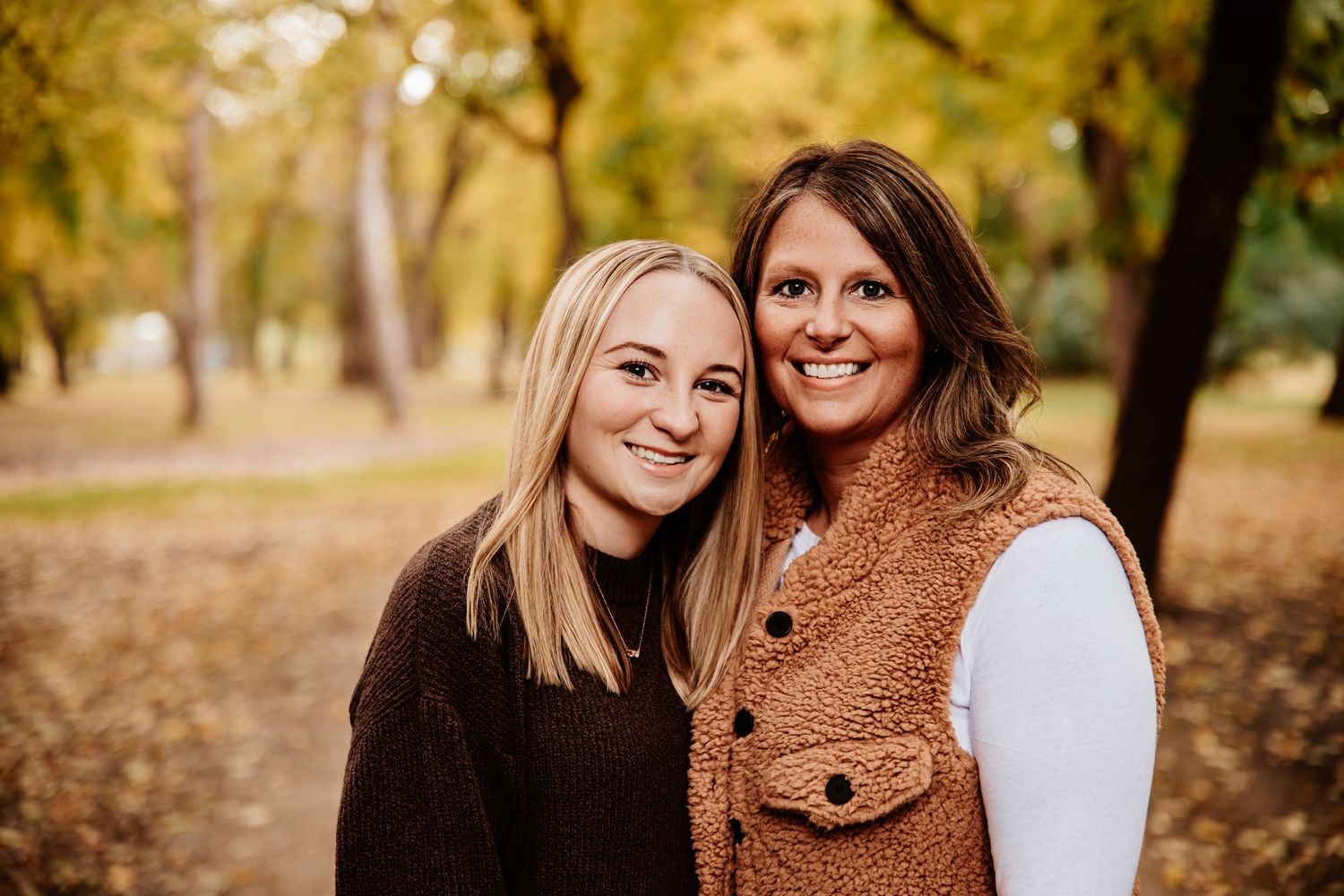 Outdoor family portrait session with warm autumn colors and natural interactions.