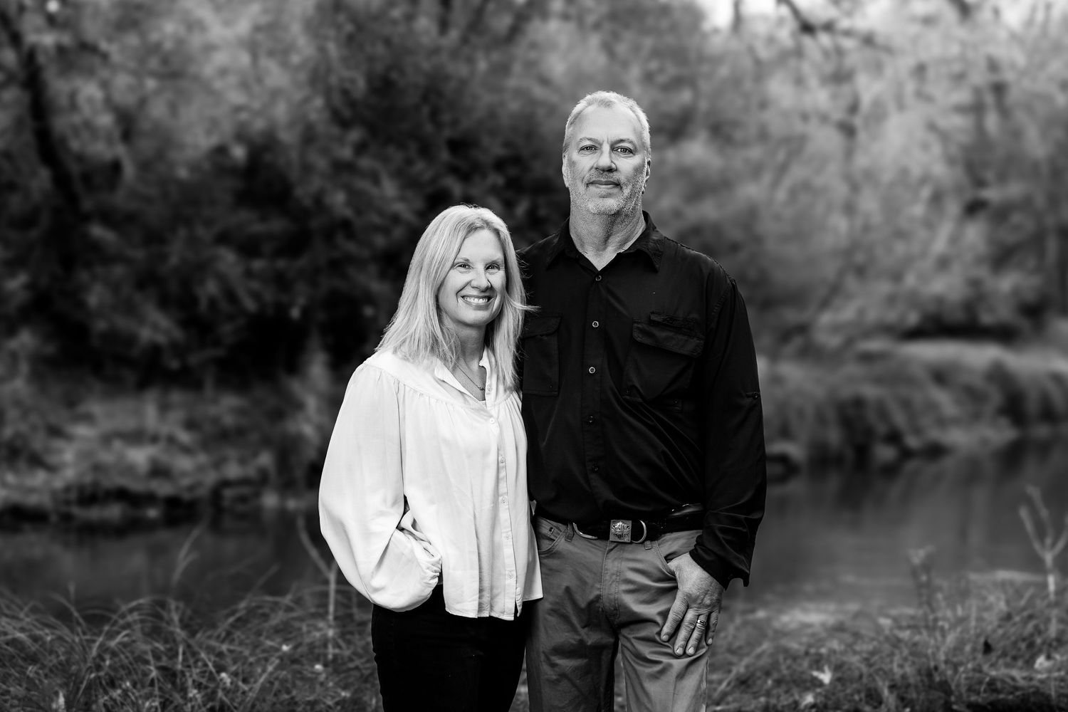 Series of black and white outdoor portraits near a pond in autumn.