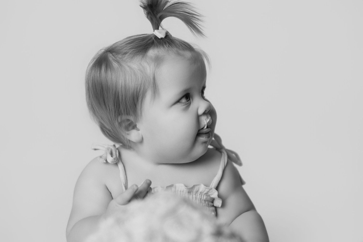 A black and white photo series showing a baby's profile and facial expressions in different candid moments.