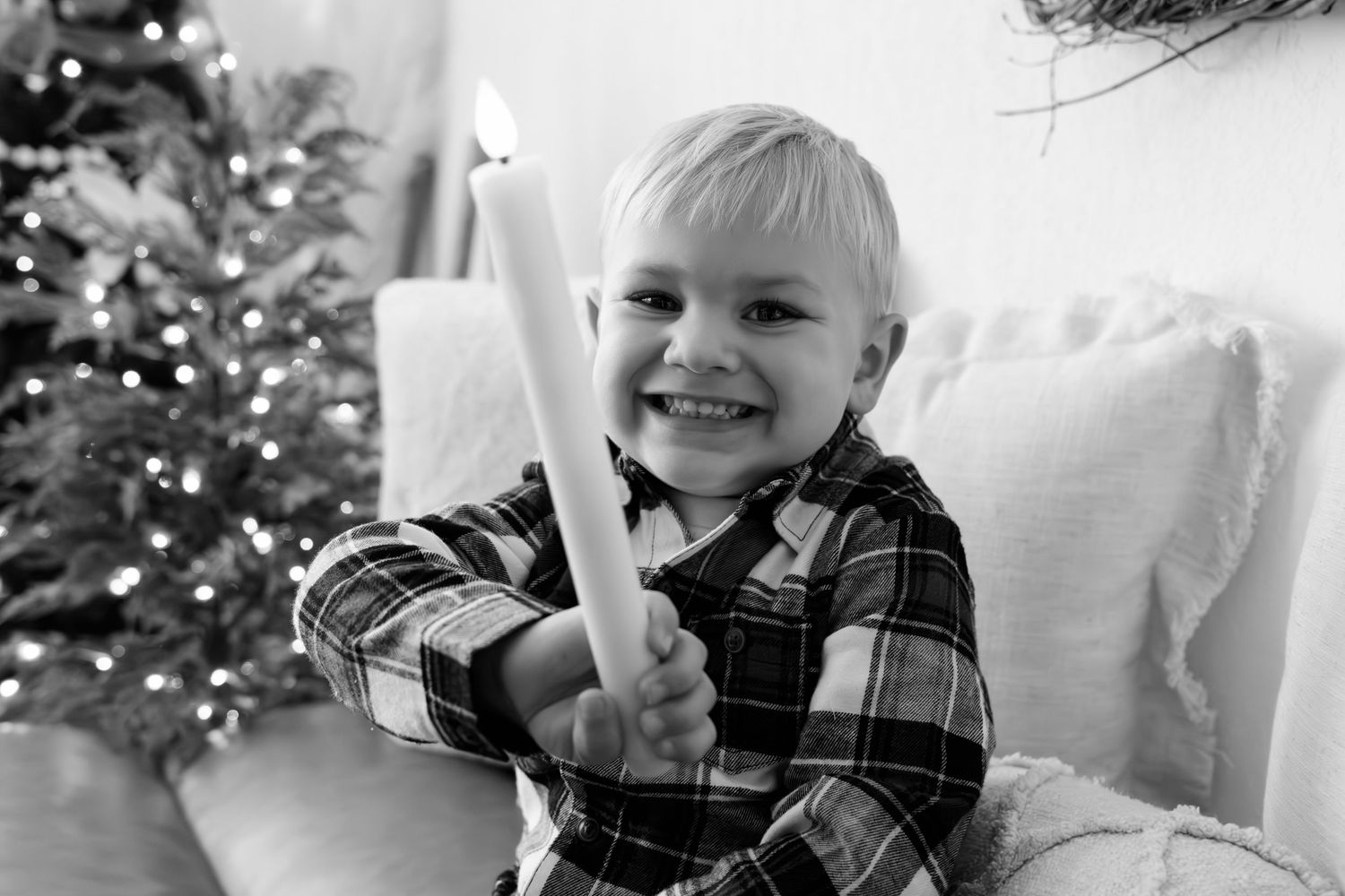 Winter portrait series with plaid clothing and Christmas decorations in background.