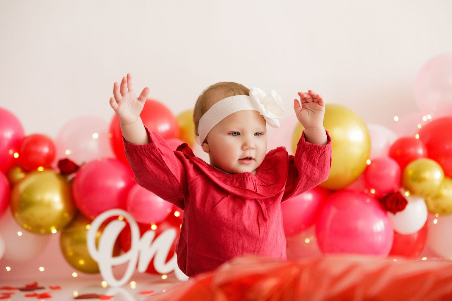 Festive backdrop with red and gold balloons arranged for a Valentine's Day photo shoot.