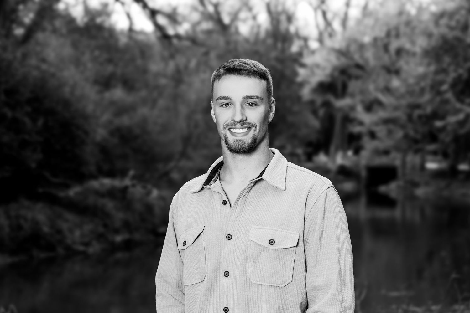 Professional headshots of adults in casual attire against a black and white outdoor background.