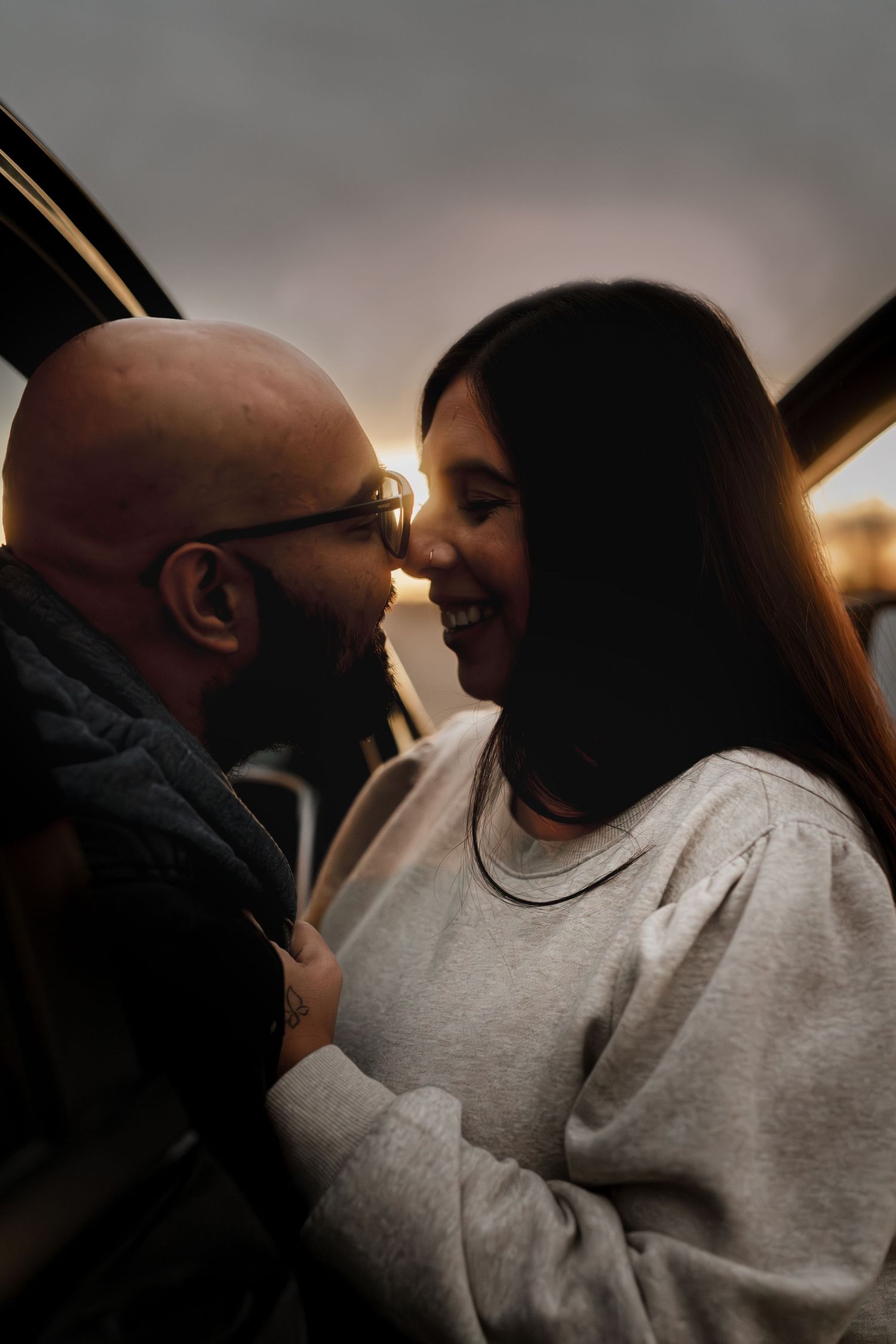 A romantic silhouette series shows a couple in intimate close-up moments during sunset with warm lighting.