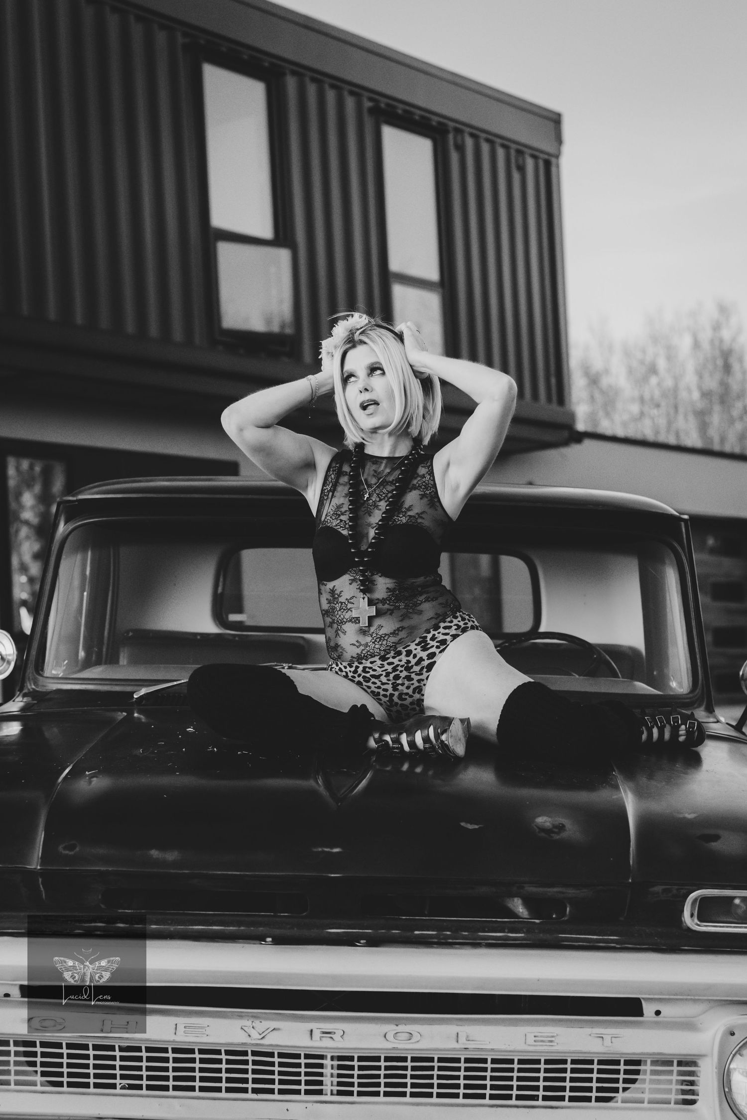 Black and white photo series showing a model posing on a vintage car hood in a polka dot dress.