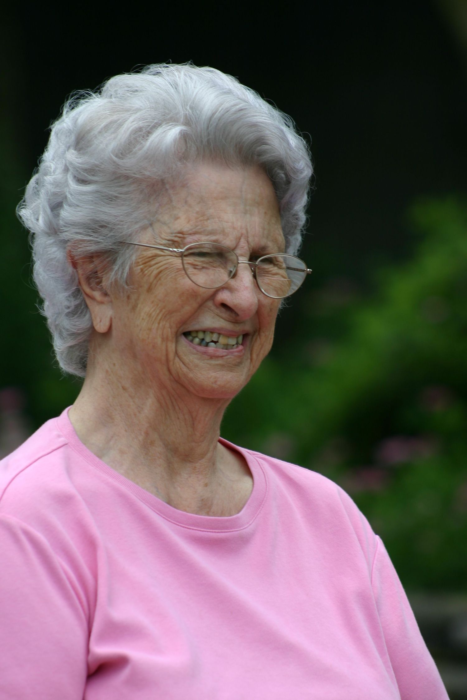 Candid outdoor portrait of elderly woman in pink shirt, natural light, Pensacola, FL. Photography by Rachel.