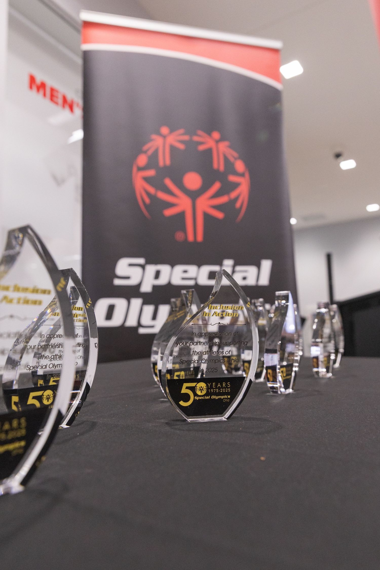 Crystal awards displayed on a table at a Special Olympics 50th anniversary celebration event.