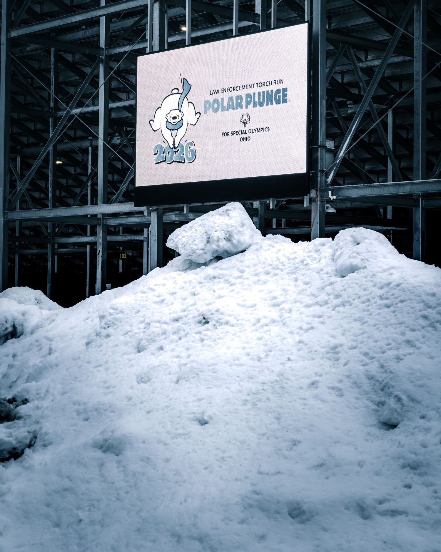 Snow pile in front of a 2025 Law Enforcement Torch Run Polar Plunge for Special Olympics Ohio sign.