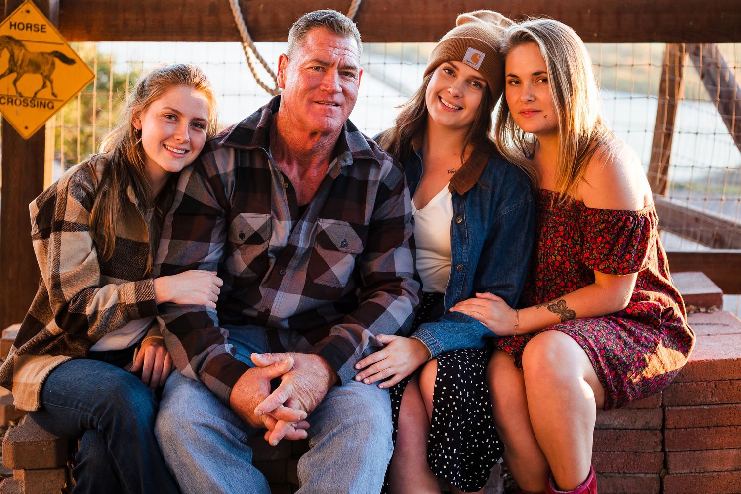 Family members gather and laugh together on a cozy porch setting during a casual social gathering.