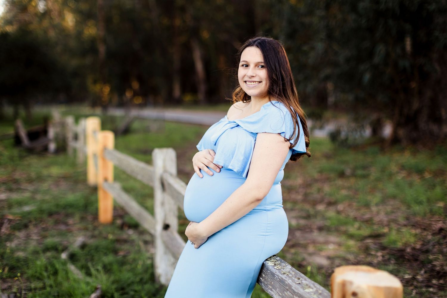 A photo series showing various angles of an expecting mother in a light blue dress outdoors in a natural setting.