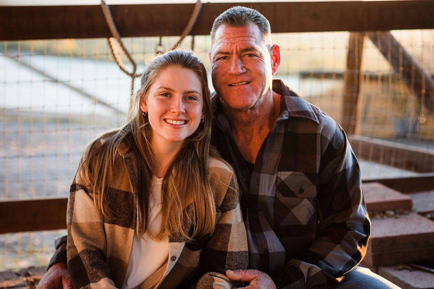 People sitting together and laughing while enjoying a casual moment in a rustic wooden setting.