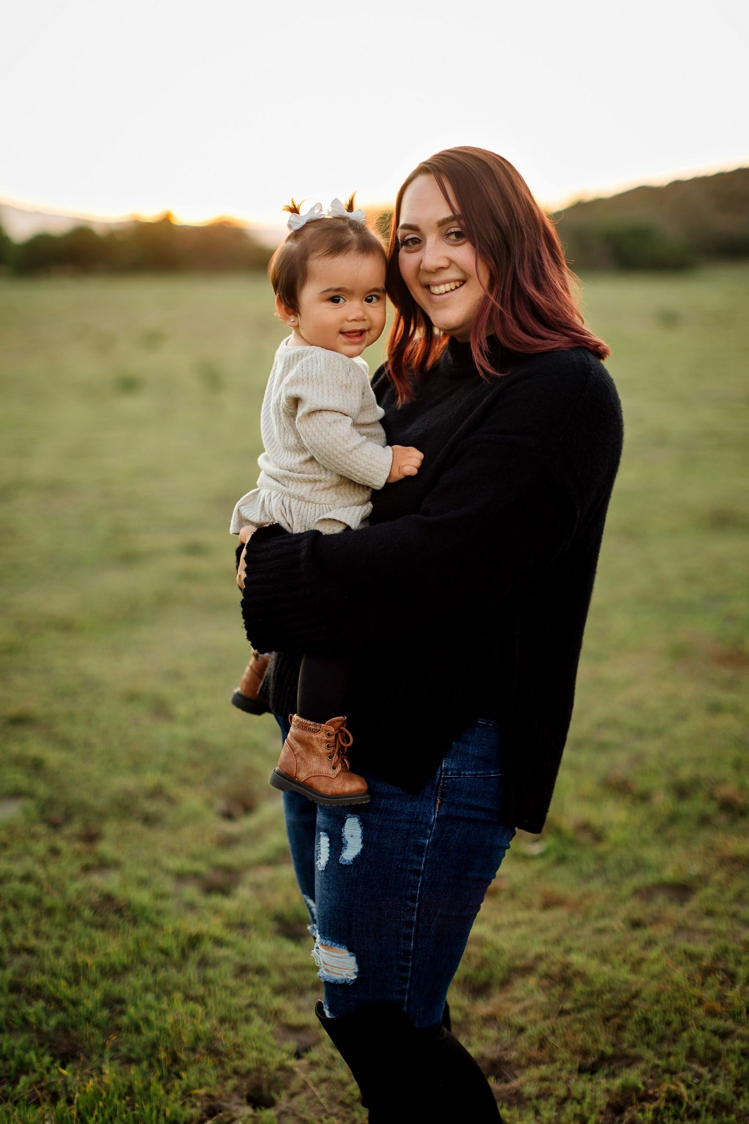 A parent and child share joyful moments together in a sunset-lit field, captured in a series of candid interactions.