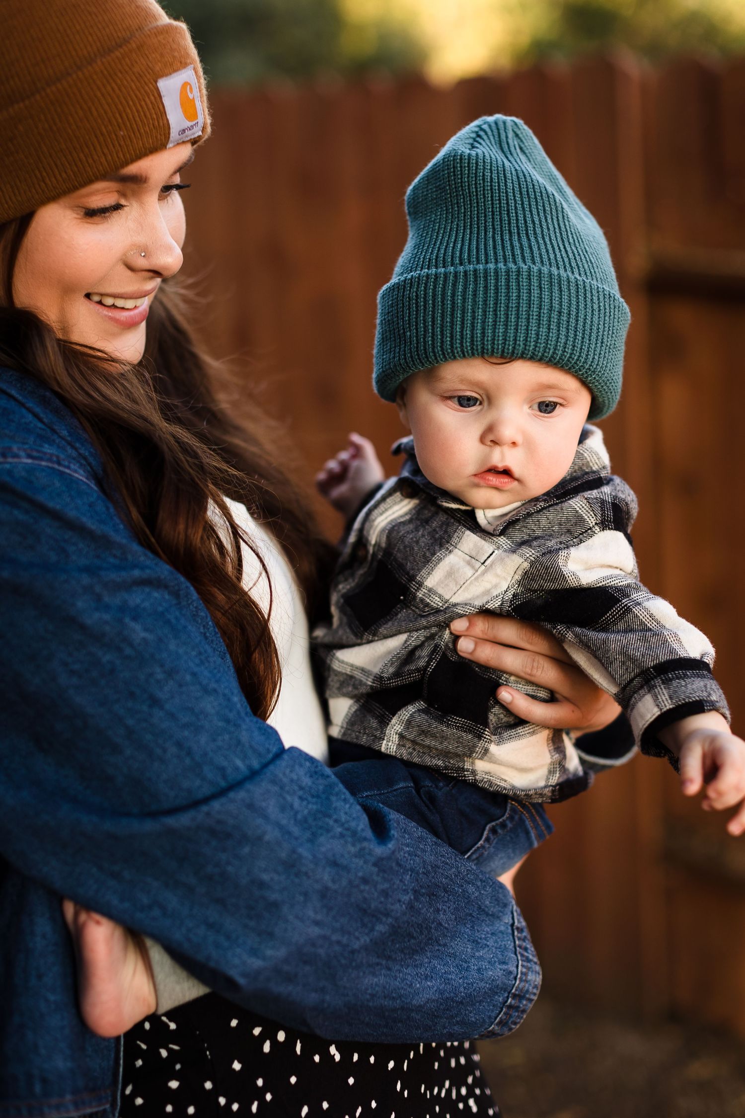 A heartwarming collection of photos showing a mother in denim holding a baby wearing a teal beanie and plaid scarf.