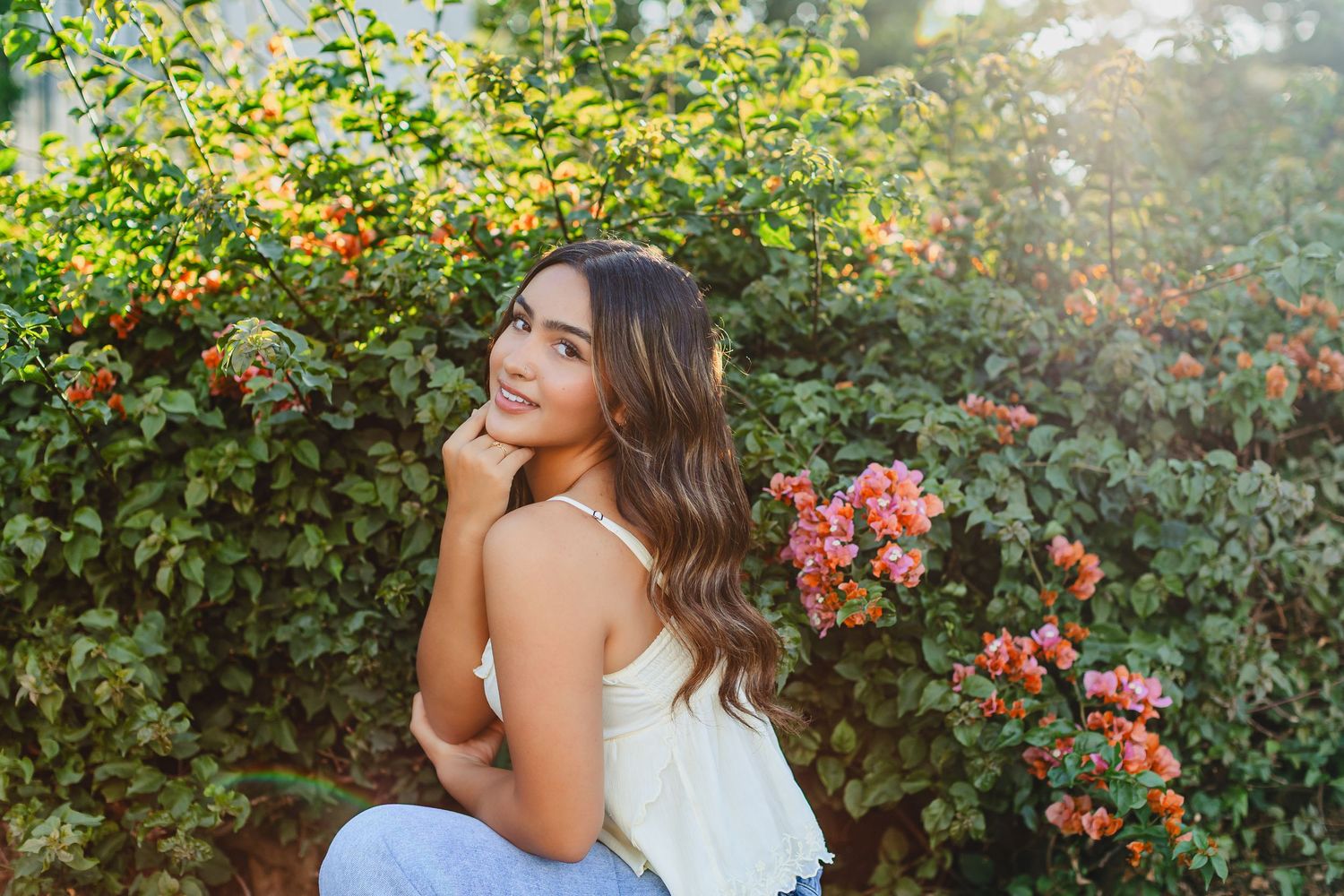 A series of outdoor portrait photos taken in a lush garden setting with blooming flowers and greenery in the background.