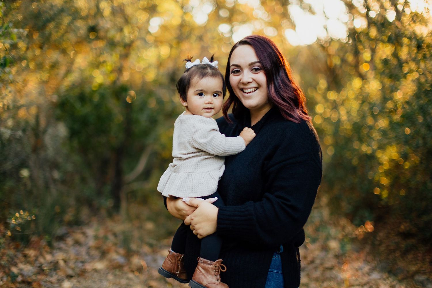 People share joyful moments together in a natural autumn setting with golden foliage in the background.