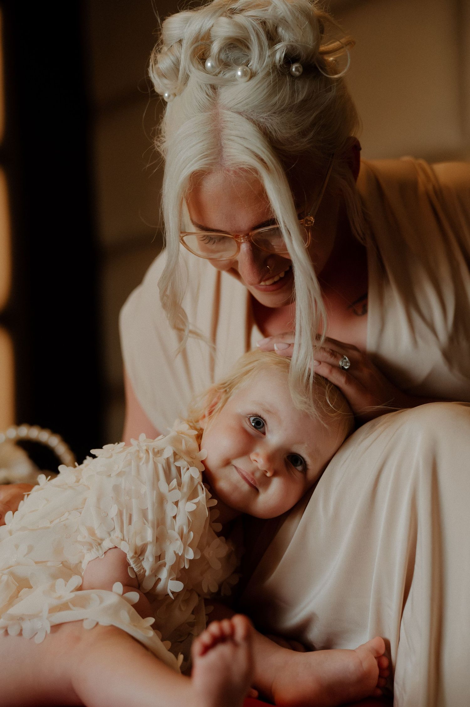A sequence of intimate photos showing tender moments between parent and baby in warm, golden lighting.