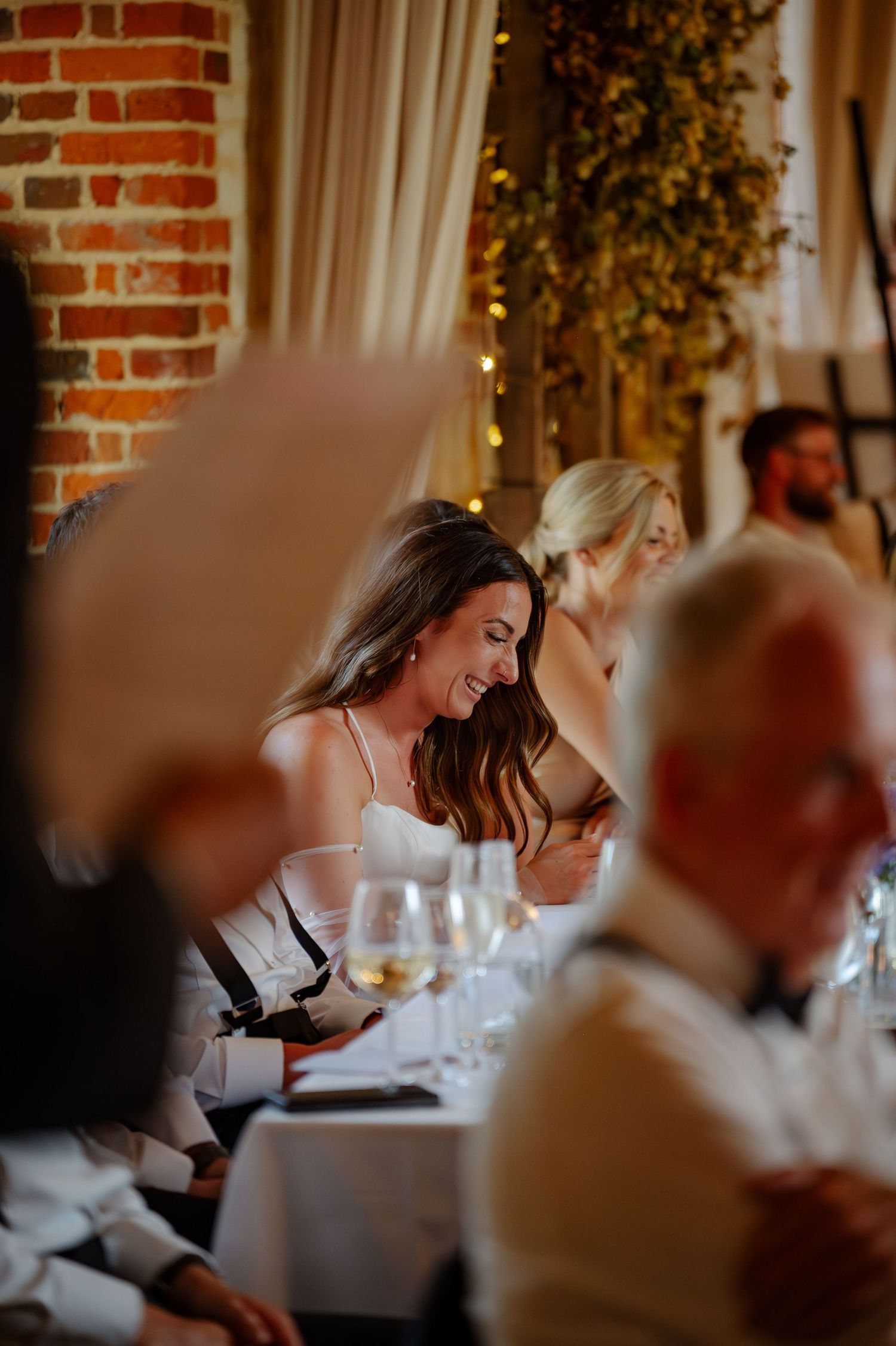 Wedding reception scene with exposed brick walls and warm lighting.
