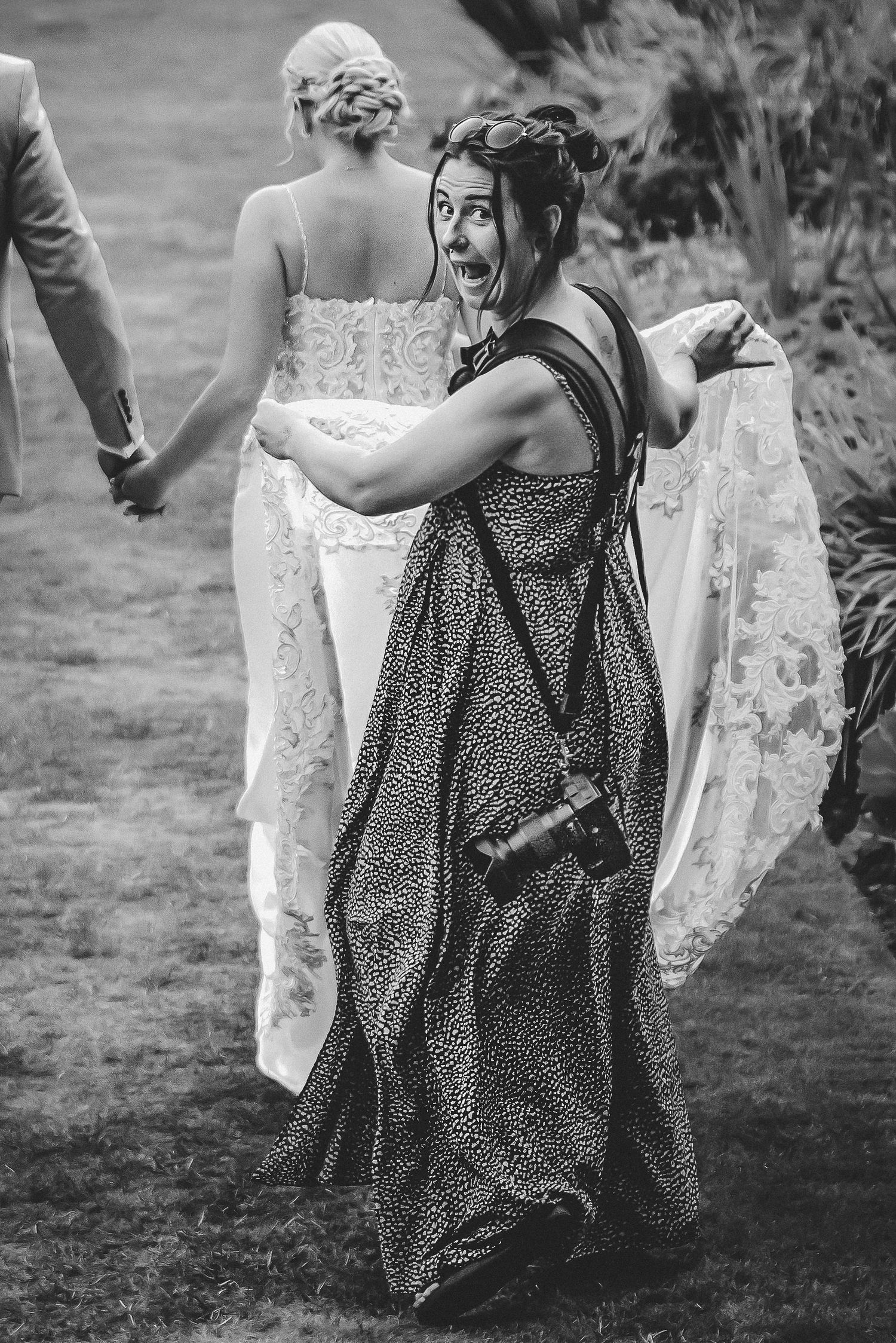 A sequence of black and white photos showing a bride in white lace dress and someone in a polka dot dress dancing together.