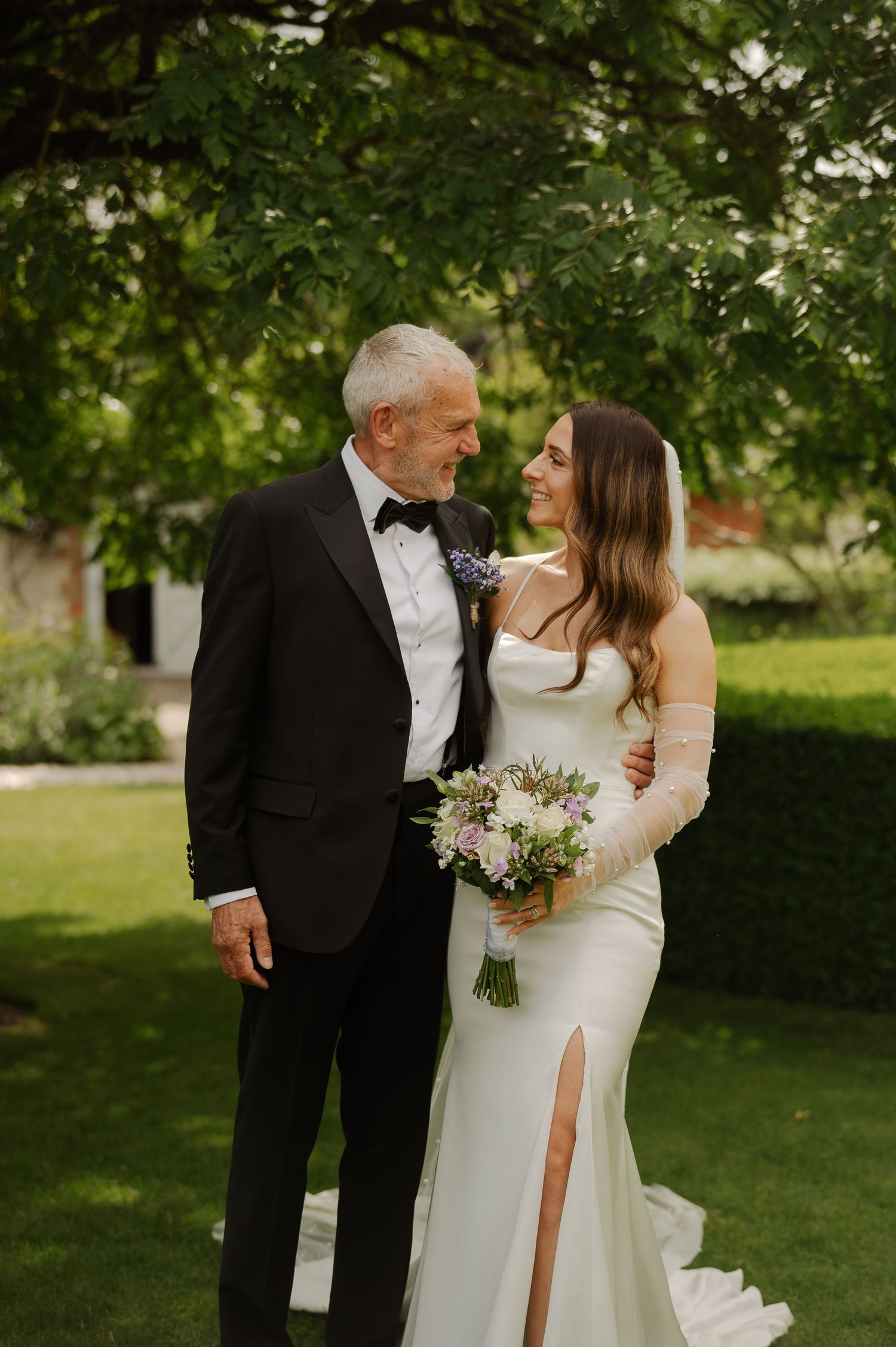 A romantic wedding couple shares intimate moments in a lush garden setting with soft natural lighting.