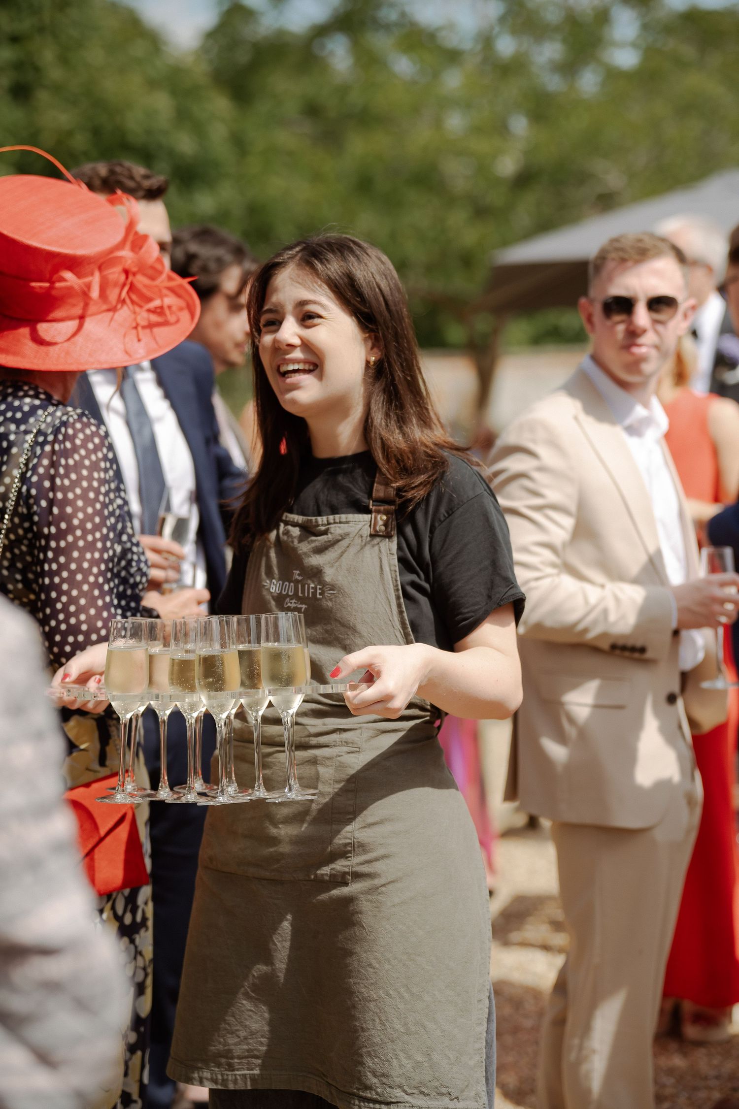 Wedding guests enjoying drinks during an outdoor cocktail reception.
