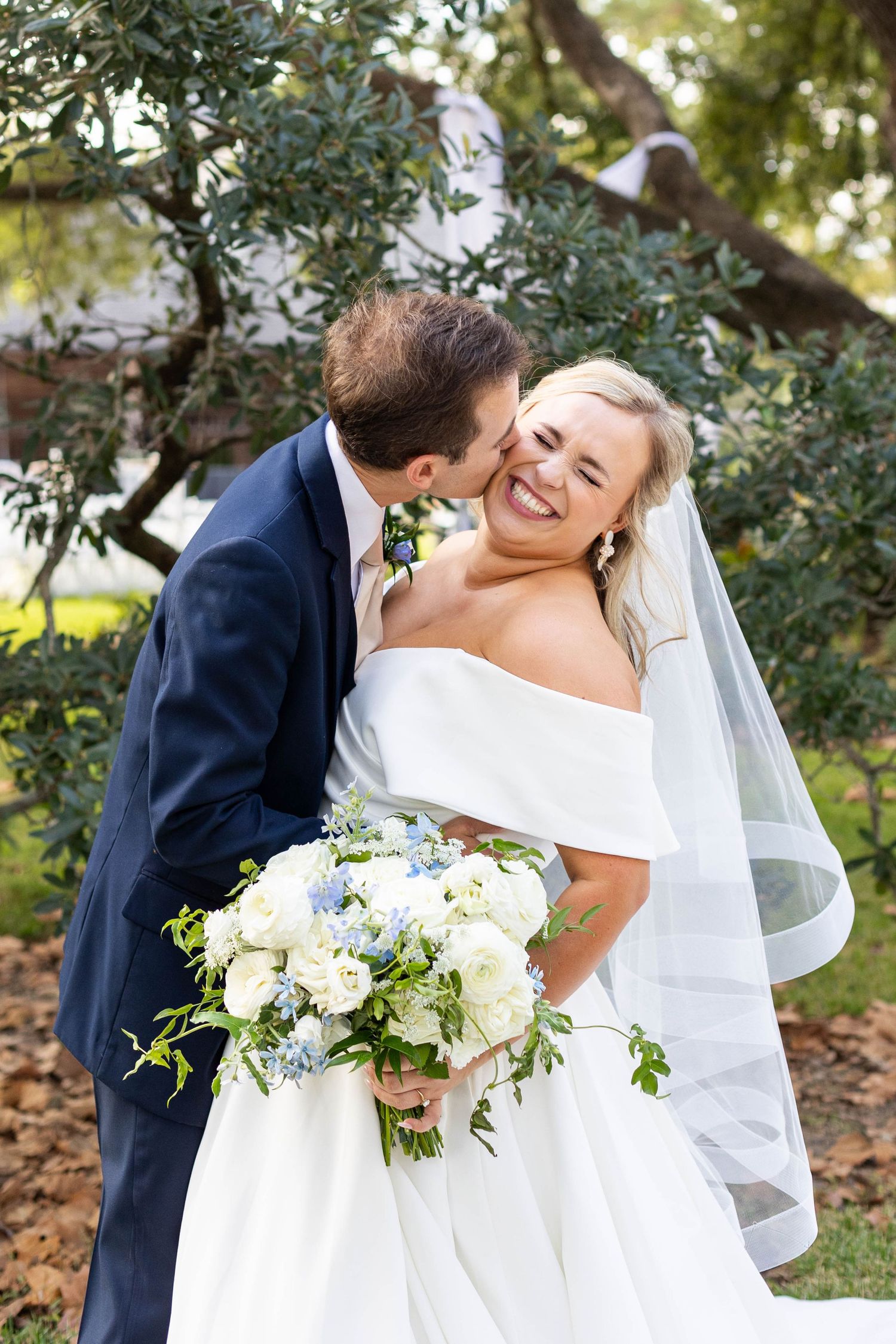 groom kisses bride wedding planner baton rouge