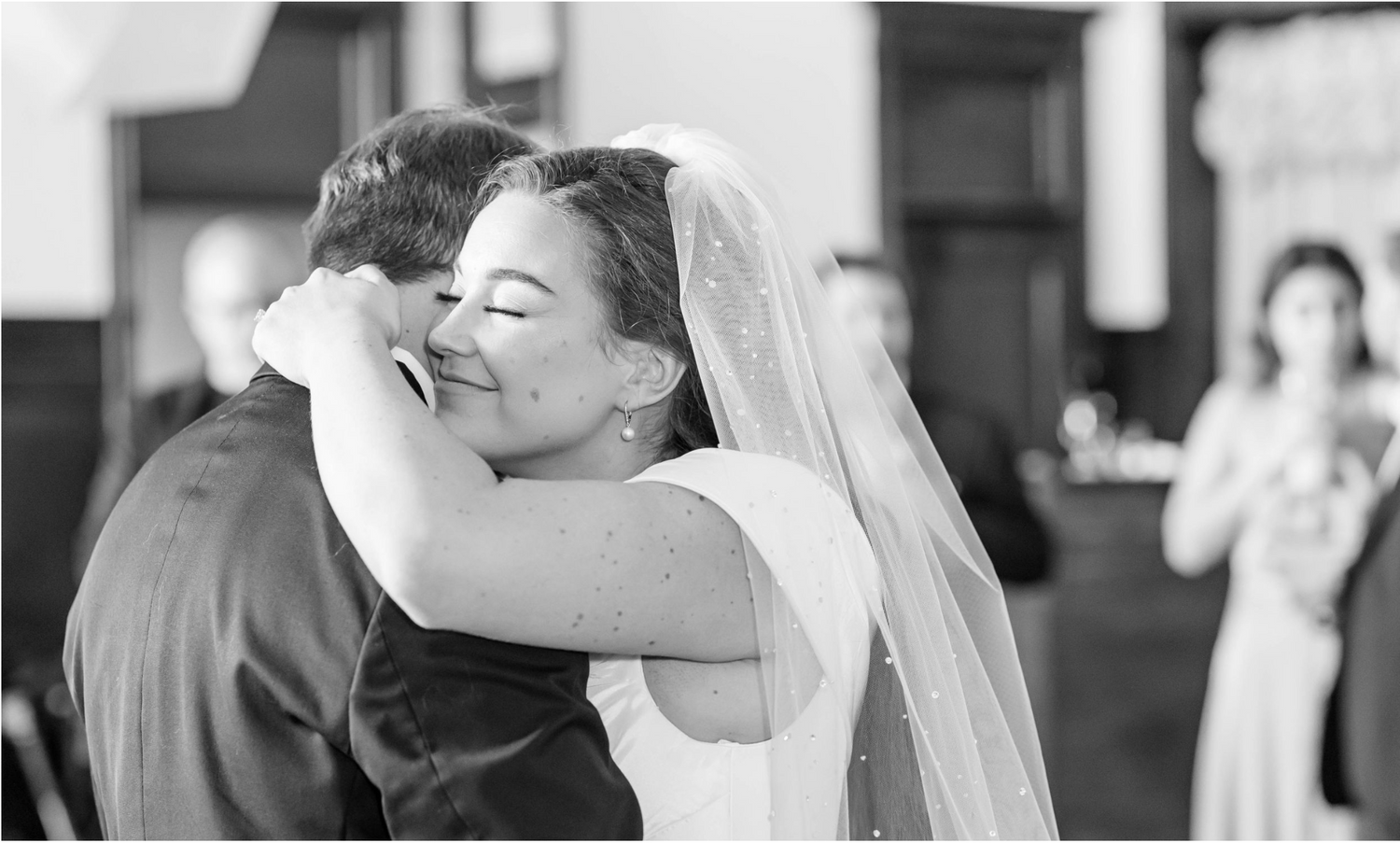 BRIDE hugs groom during first dance