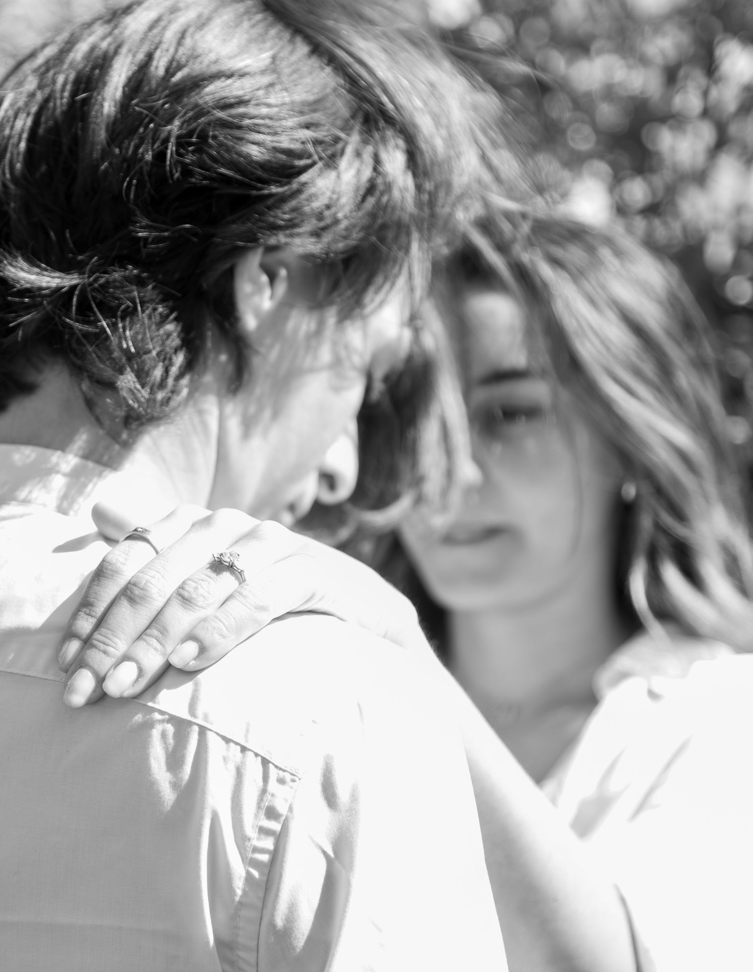 over the shoulder black and white moody engagement photo