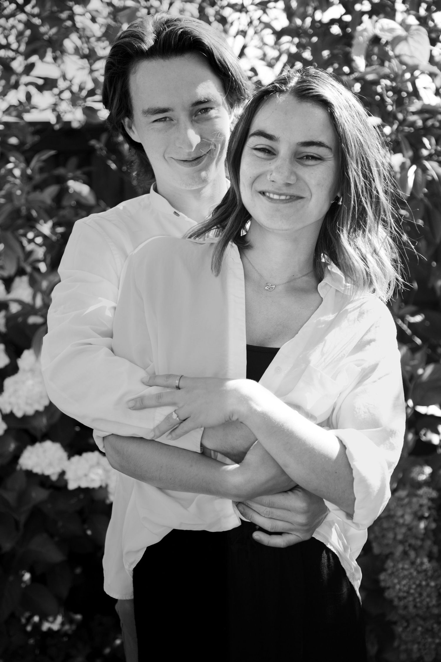 Loved up and engaged, black and white candid engagement photo shoot