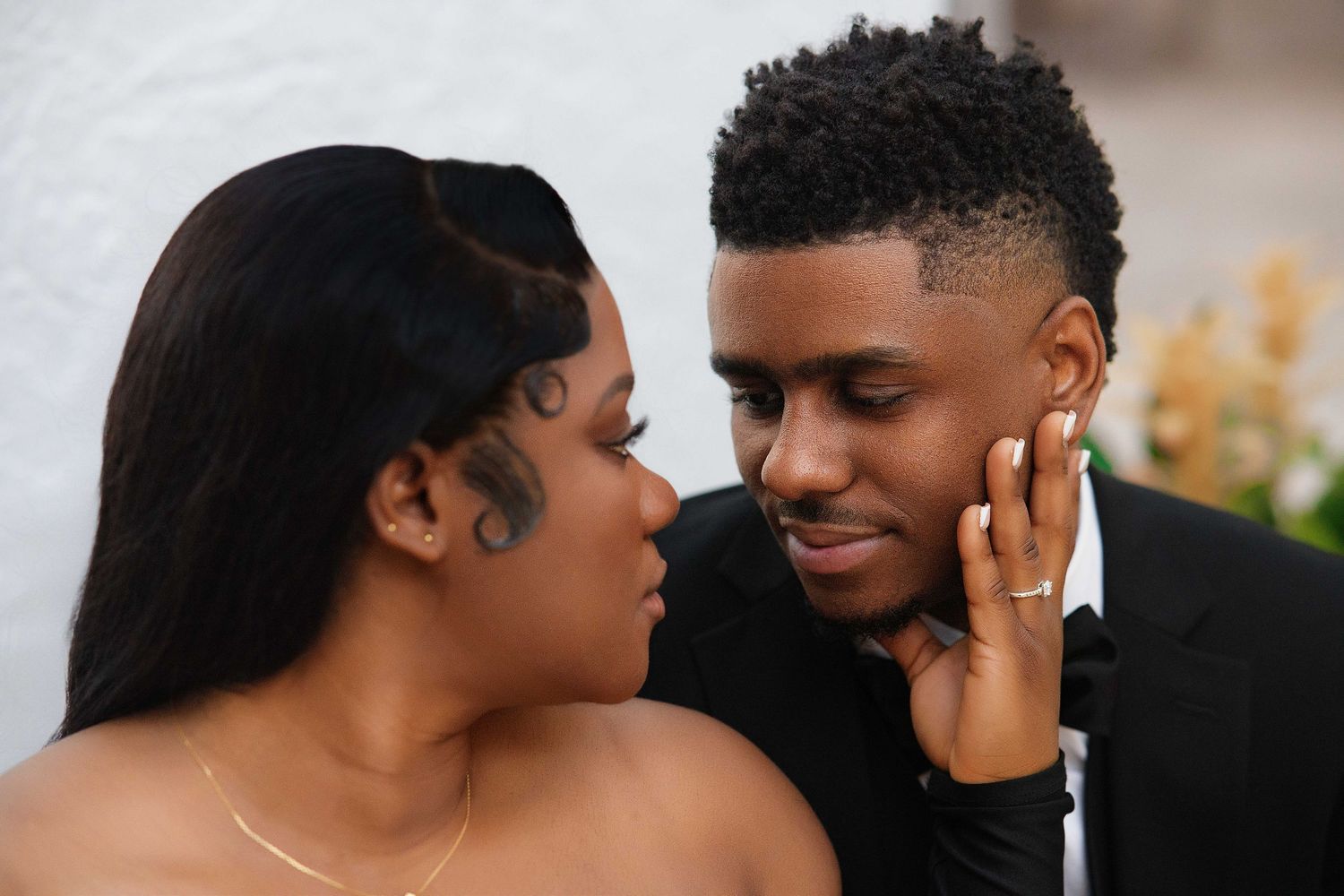 Close-up of a Black couple sharing an intimate romantic moment during a photo session.