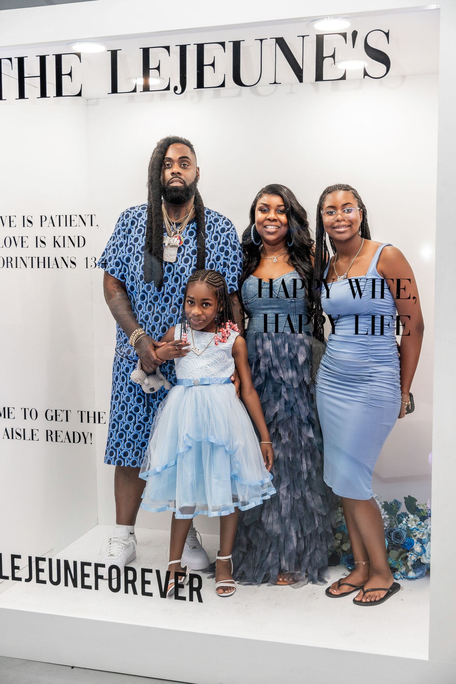 A family of four poses inside The Lejeunes photo frame, featuring a little girl in a blue tutu dress.
