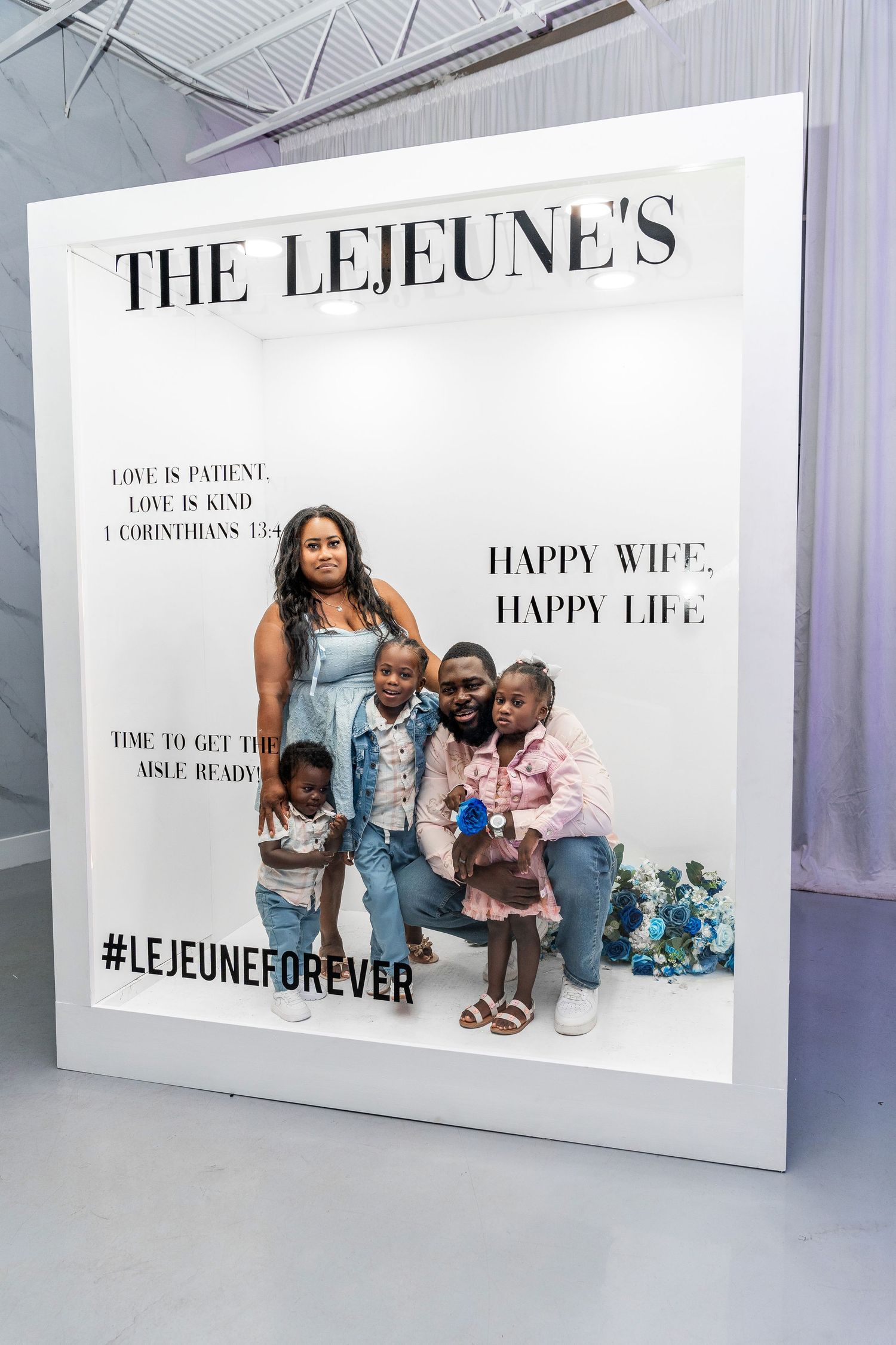 A family of five in coordinating denim outfits smiles together inside The Lejeunes decorative photo frame.