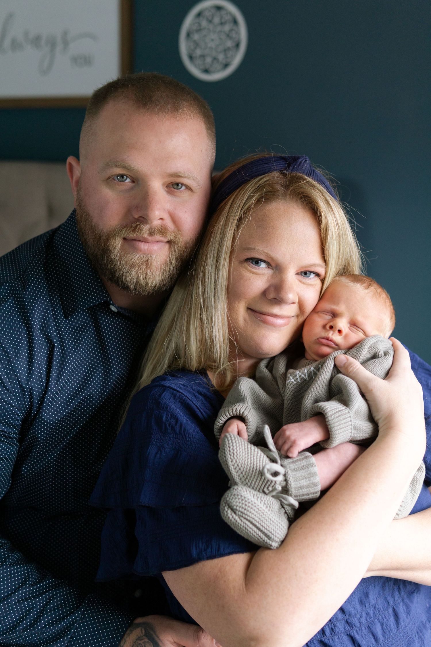 Family holding their newborn during a lifestyle newborn session in South Jersey.