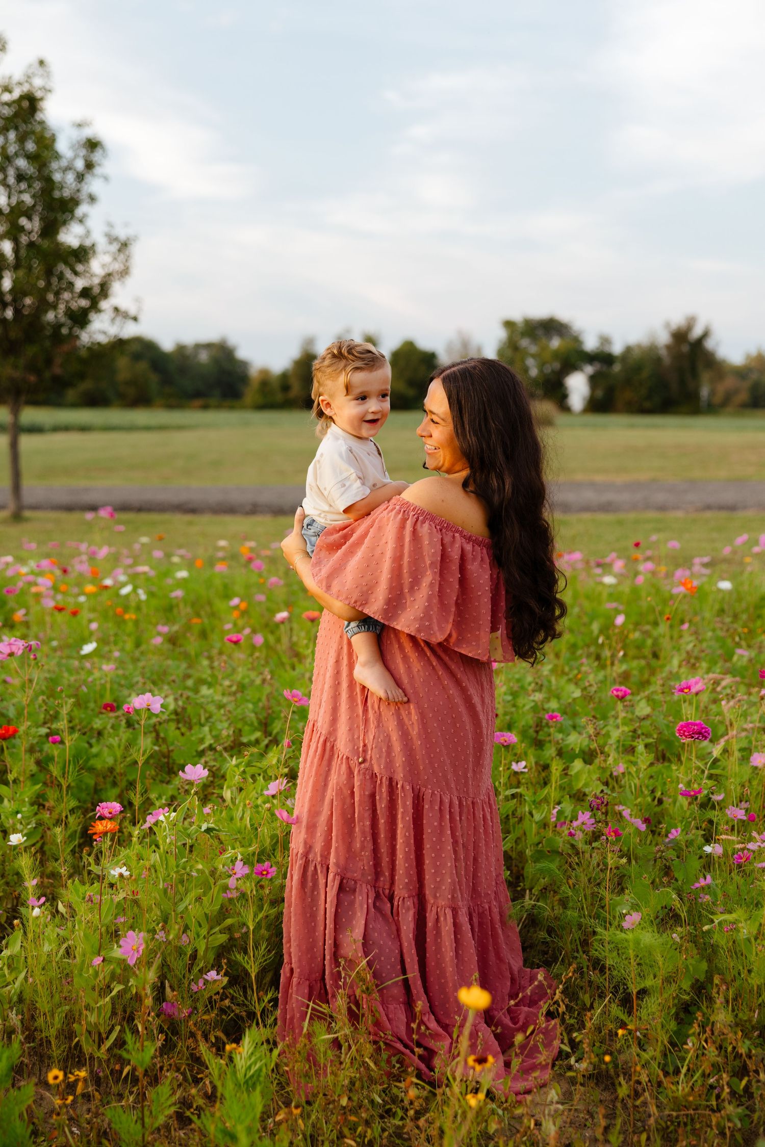 Expectant mother and her toddler son in a field of flowers during a maternity session in South Jersey.