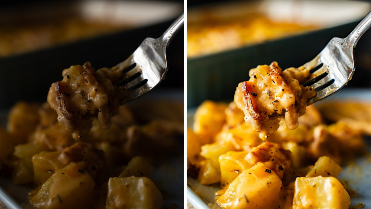 A fork pierces into cheesy potato and ham casserole on a dark plate highlighting its rich, melty texture and golden color.