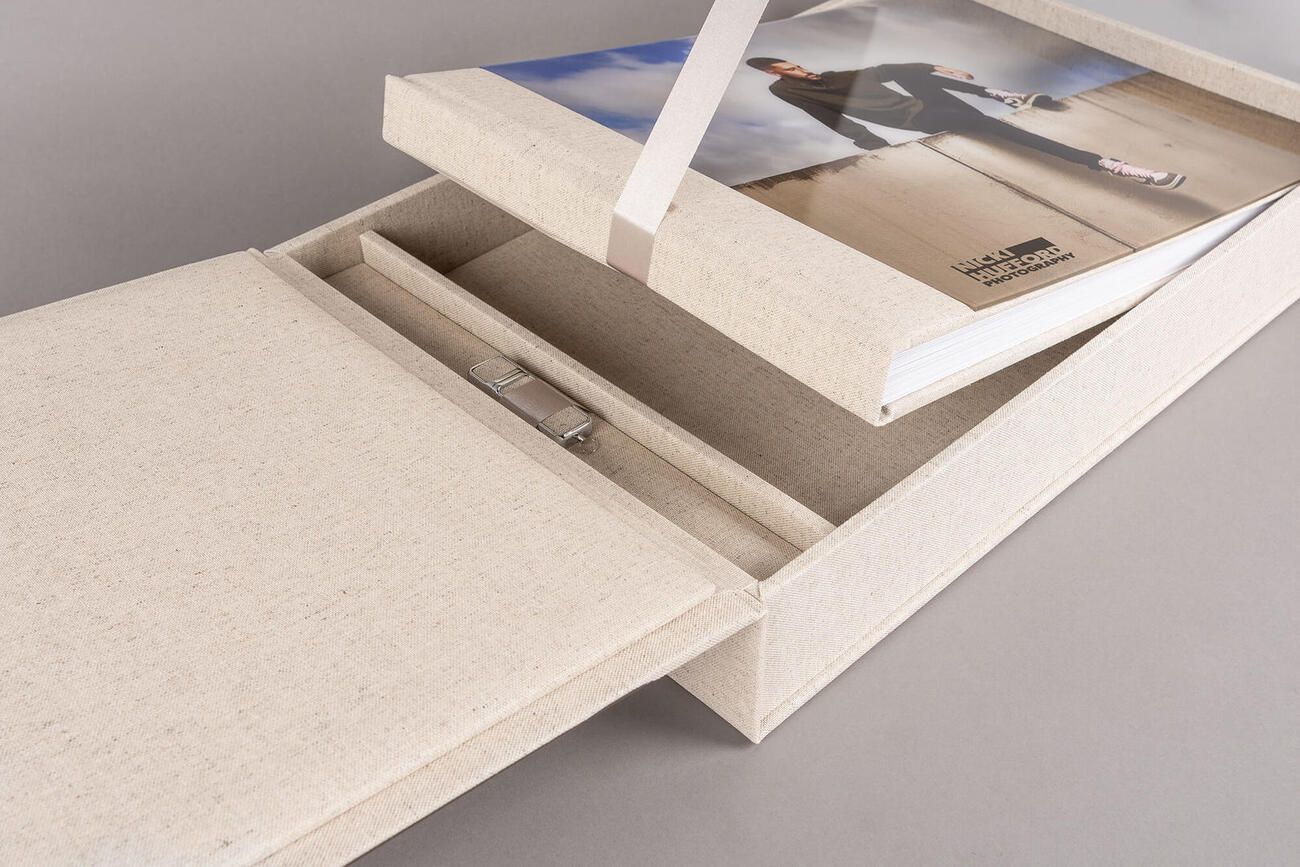 White drawer slides smoothly on metal rails mounted to a wooden cabinet frame.